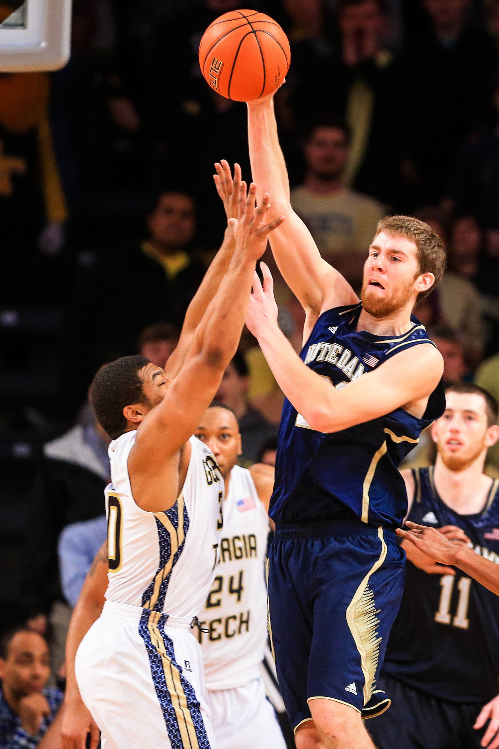 Jan 11, 2014; Atlanta, GA, USA; Notre Dame Fighting Irish forward Austin Burgett (20) passes over Georgia Tech Yellow Jackets guard Corey Heyward (30) in the second half at Hank McCamish Pavilion. Georgia Tech won 74-69. Mandatory Credit: Daniel Shirey-USA TODAY Sports