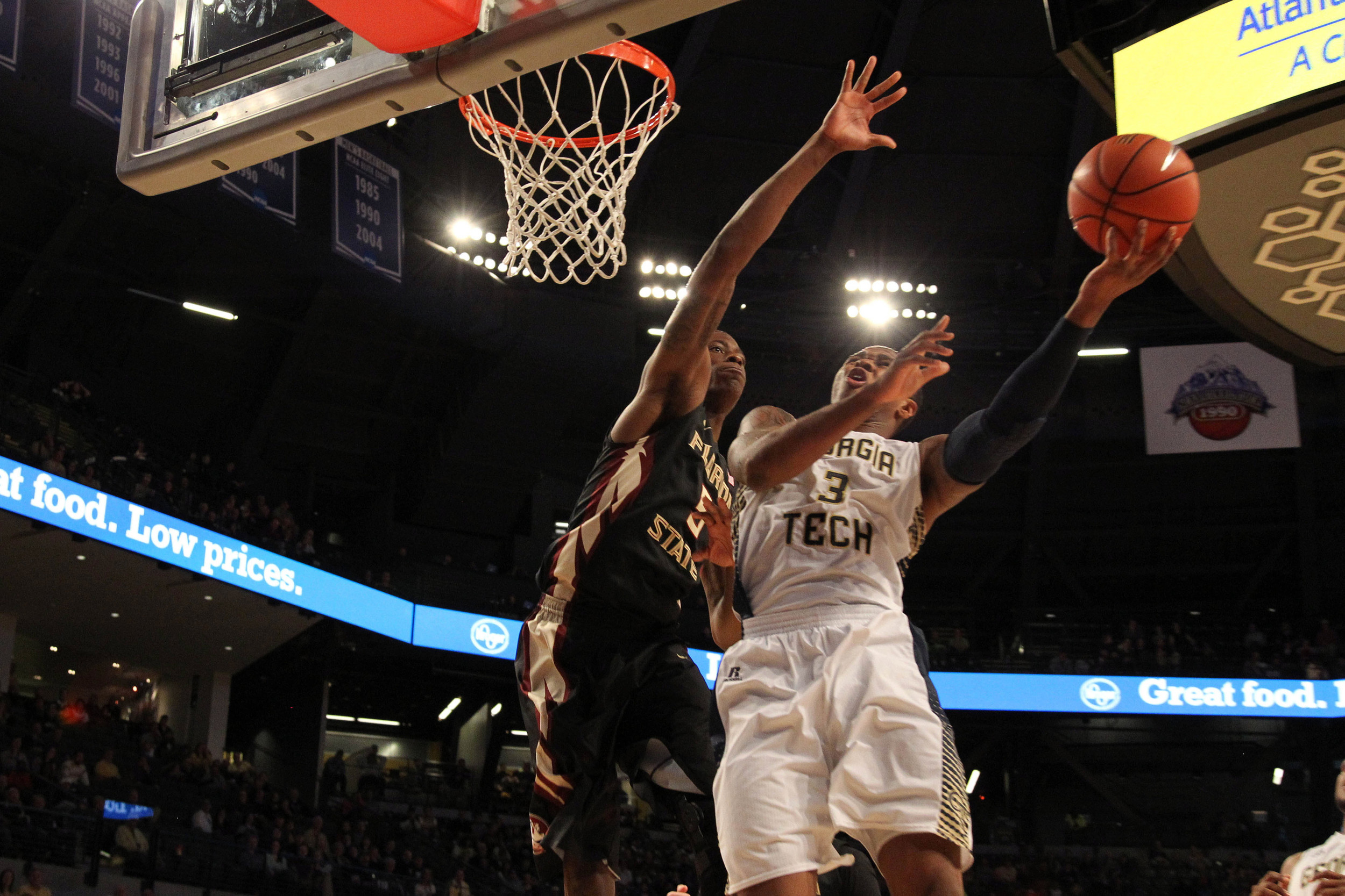 Feb 14, 2015; Atlanta, GA, USA; Georgia Tech Yellow Jackets forward Marcus Georges-Hunt (3) shoots the ball past Florida State Seminoles forward Jarquez Smith (5) in the second half at McCamish Pavilion. Florida State defeated Georgia Tech 57-53.