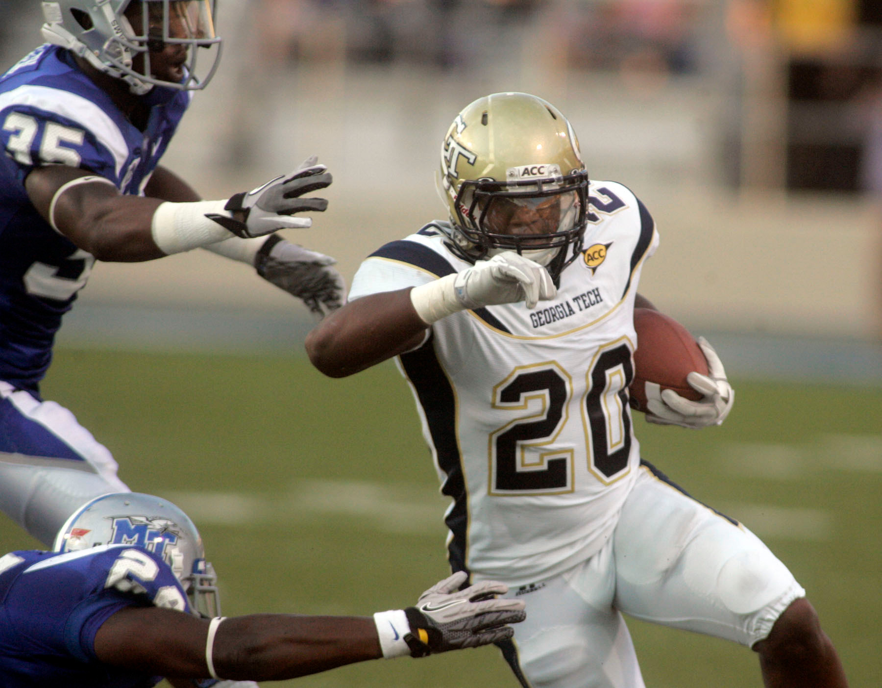 Georgia Tech's Roddy Jones slips past Middle Tennessee's Derrick Crumpton, bottom, and Craig Allen during an NCAA college football game, Saturday, Sept. 10, 2011, in Murfreesboro, Tenn. (AP Photo/The Daily News Journal, Aaron Thompson)