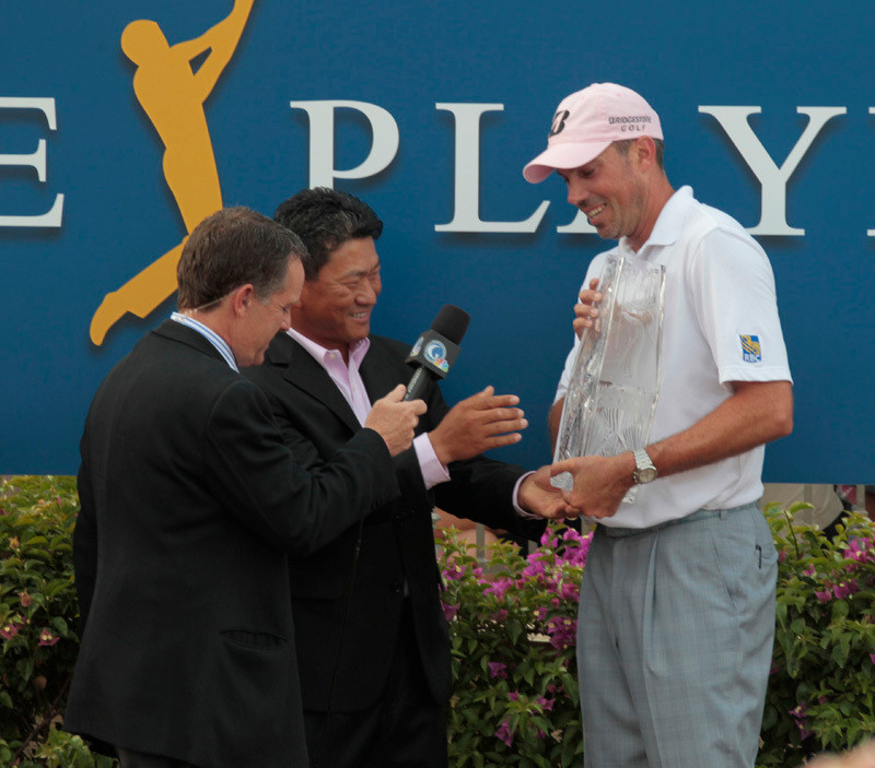 K J Choi gives the trophy to Matt Kuchar for winning the Players Championship on May 13, 2012. Mandatory Photo Credit: Vern Verna / Ai Wire