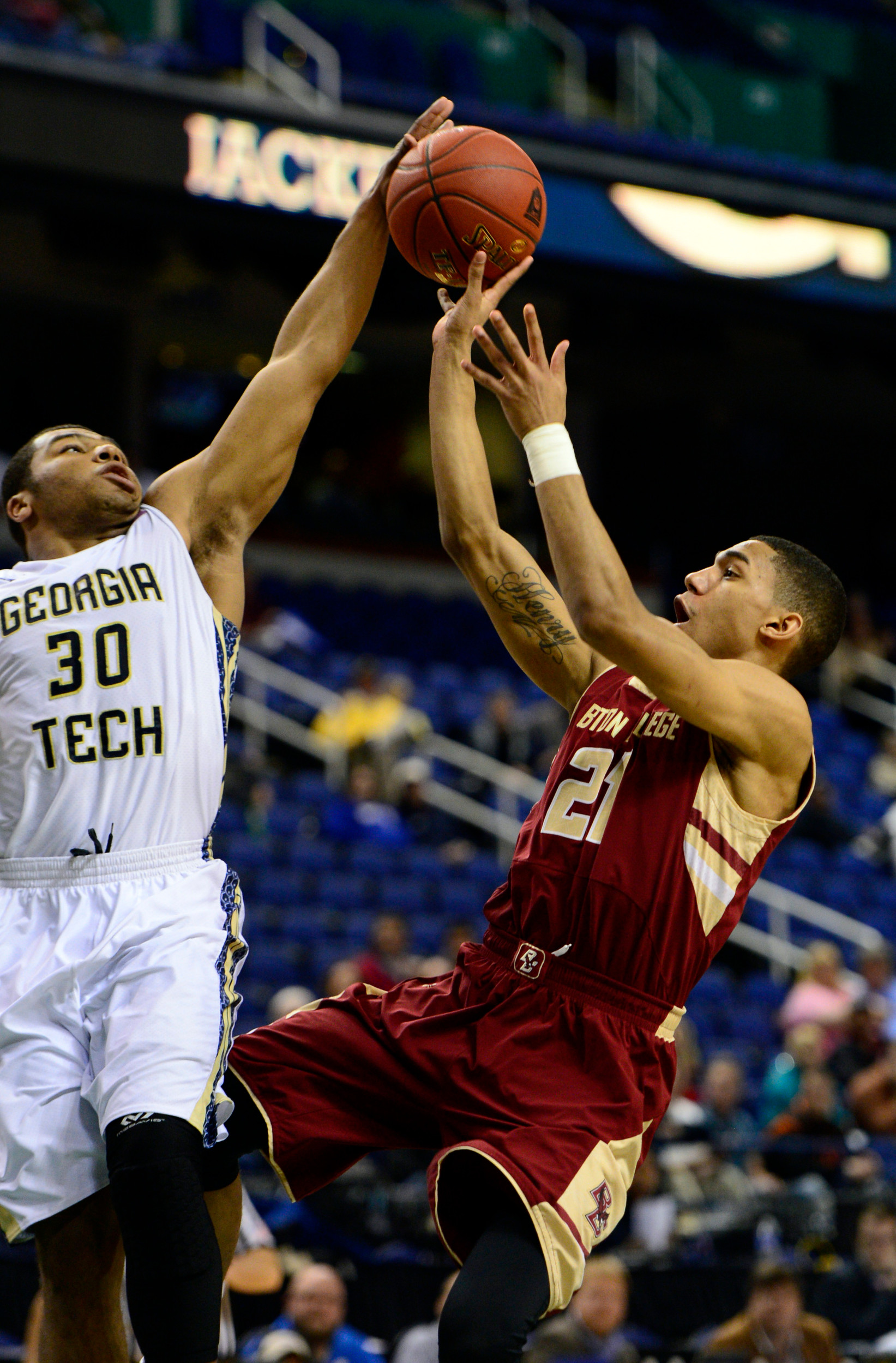Mar 12, 2014; Greensboro, NC, USA; Georgia Tech Yellow Jackets guard Corey Heyward (30) blocks a shot by Boston College Eagles guard Olivier Hanlan (21) during the first round of the ACC Tournament at Greensboro Coliseum. Georgia Tech defeated Boston College 73-70 in overtime. Mandatory Credit: John David Mercer-USA TODAY Sports