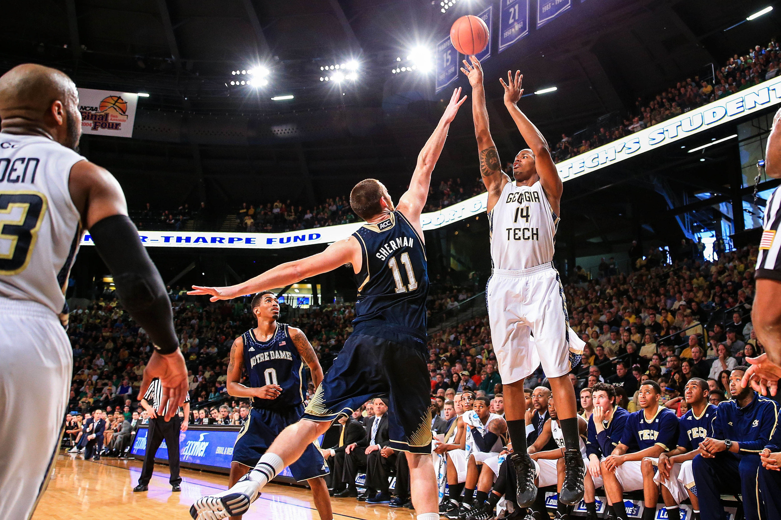 Jan 11, 2014; Atlanta, GA, USA; Georgia Tech Yellow Jackets guard/forward Jason Morris (14) shoots a three point basket over Notre Dame Fighting Irish center Garrick Sherman (11) in the second half at Hank McCamish Pavilion. Georgia Tech won 74-69. Mandatory Credit: Daniel Shirey-USA TODAY Sports