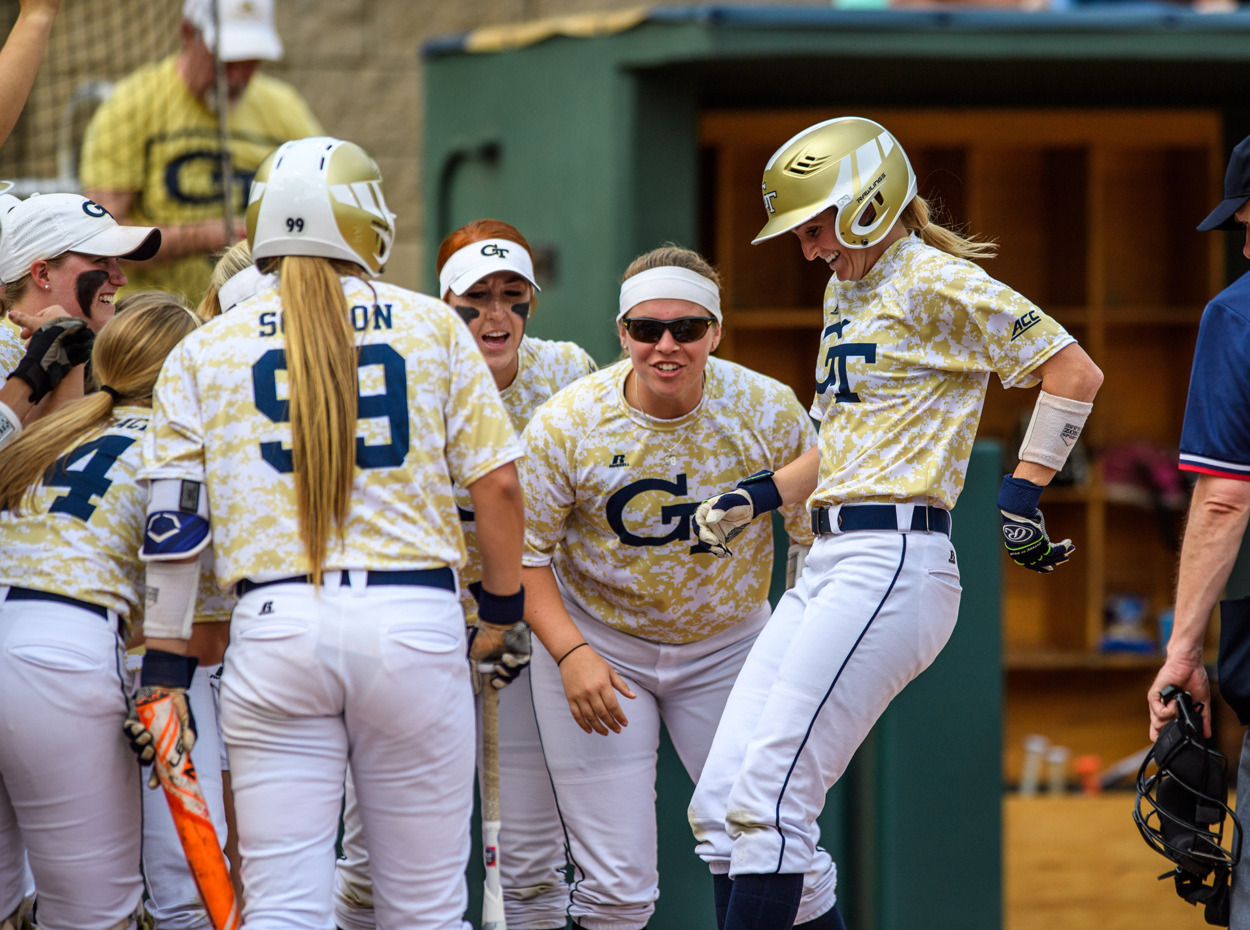 The team greets Colleen Darragh (24) at the plate after her home run