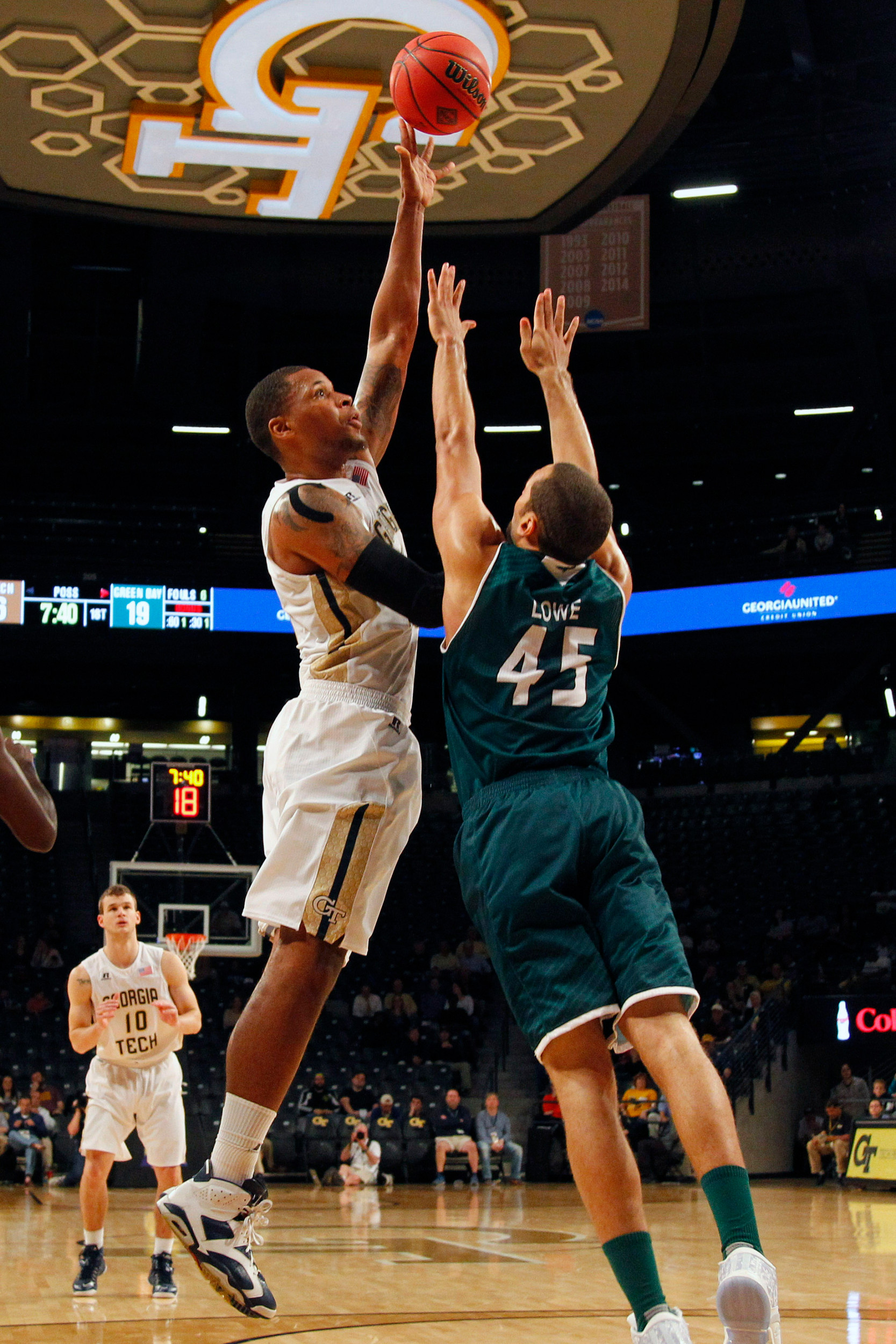 Yellow Jackets forward Nick Jacobs shoots the ball over Green Bay Phoenix forward Kenneth Lowe in the first half at McCamish Pavilion. Credit: Brett Davis-USA TODAY Sports