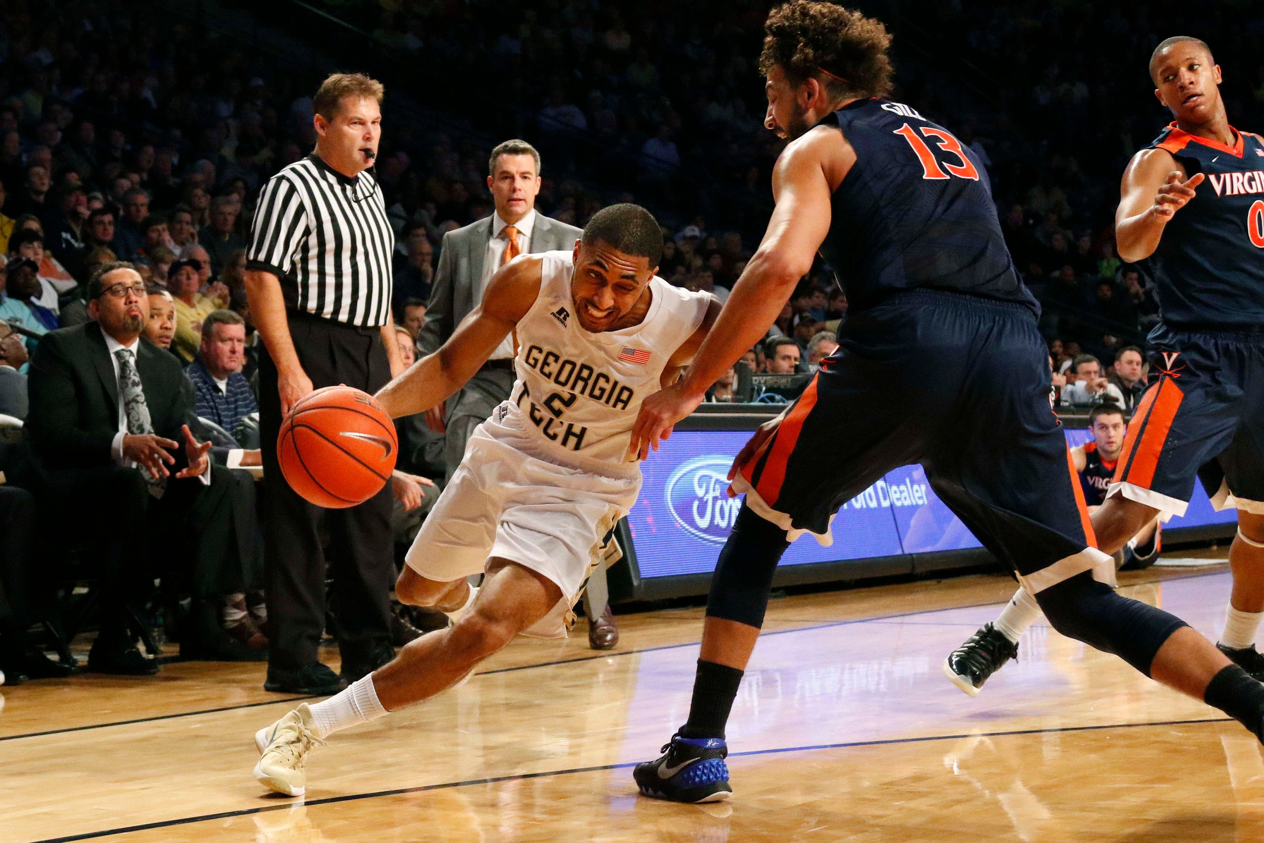 Adam Smith drives past Virginia Cavaliers forward Anthony Gill. Brett Davis-USA TODAY Sports
