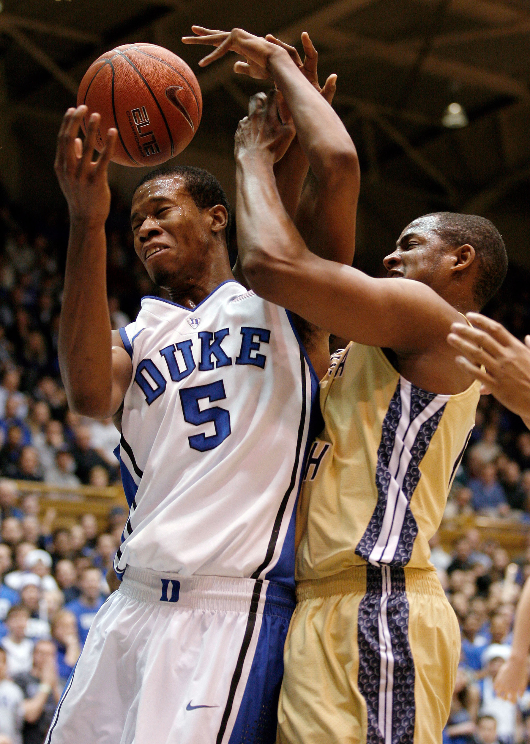 Jan 7, 2014; Durham, NC, USA; Duke Blue Devils forward Rodney Hood (5) and Georgia Tech Yellow Jackets guard/forward Jason Morris (14) scramble for a rebound at Cameron Indoor Stadium. Mandatory Credit: Mark Dolejs-USA TODAY Sports