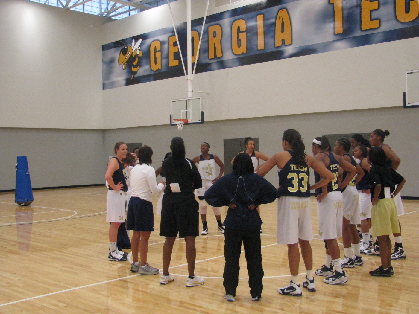 Coach Joseph addresses team before practice on the brand new Zelnak Center floor