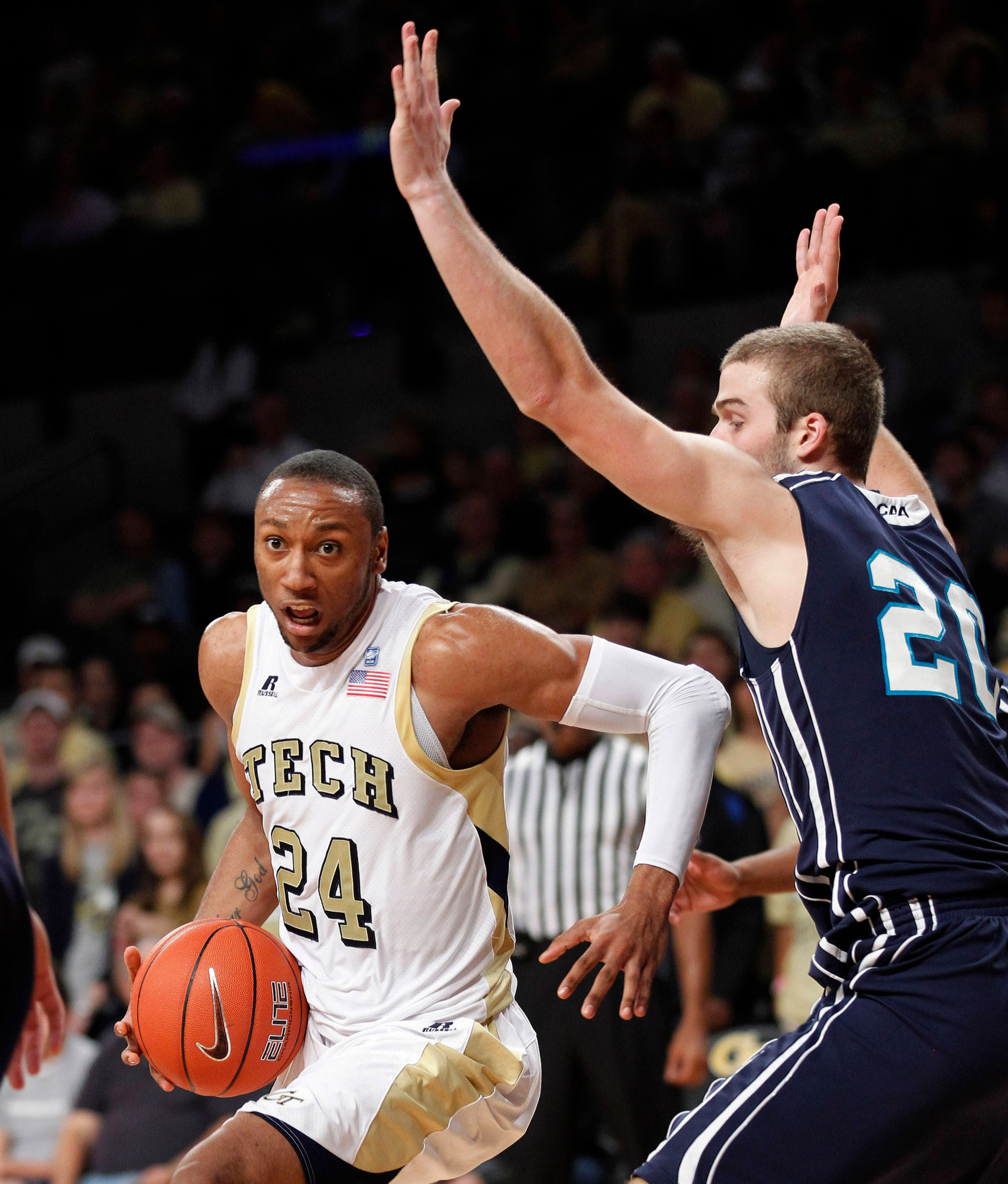 Georgia Tech forward Kammeon Holsey (24) tries to get past North Carolina-Wilmington forward Dylan Sherwood (20) in the first half. (AP Photo/John Bazemore)