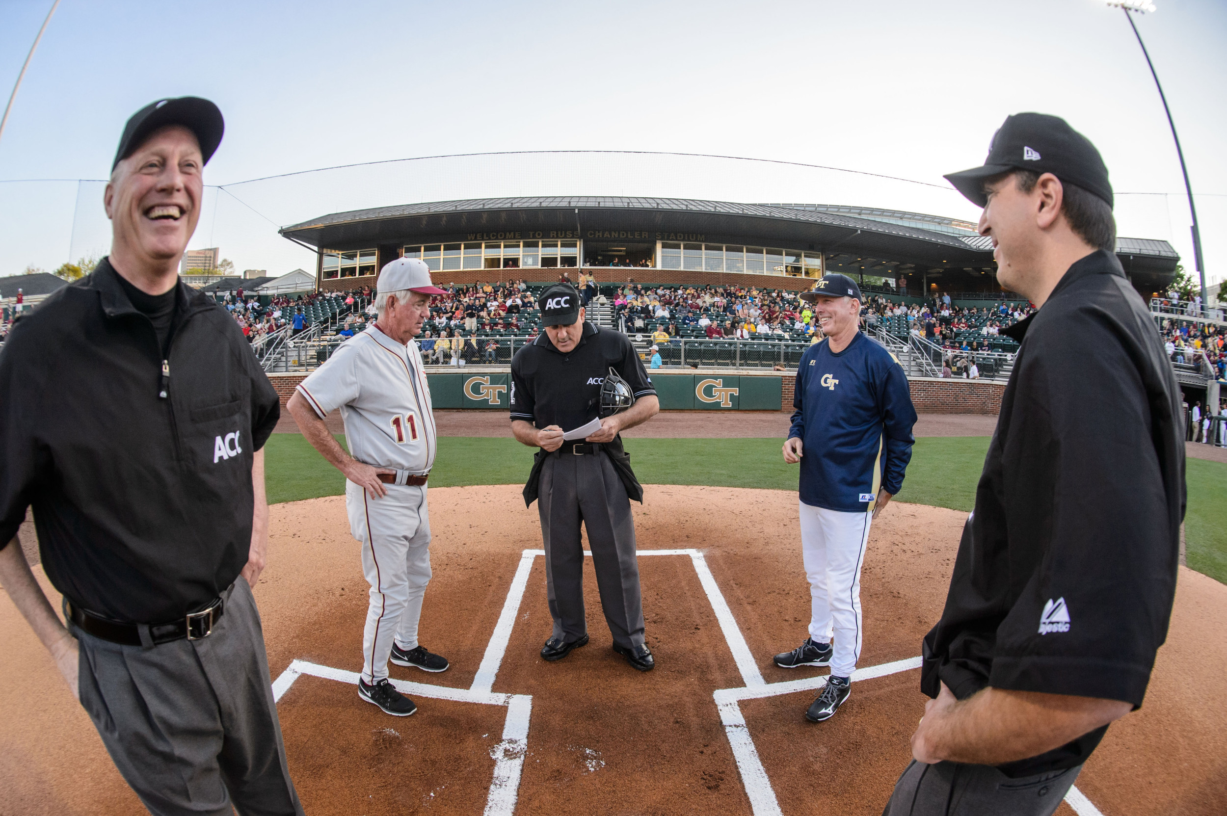 Coach Danny Hall (17) of Georgia Tech and Coach Mike Martin of Florida State meet with the umpires