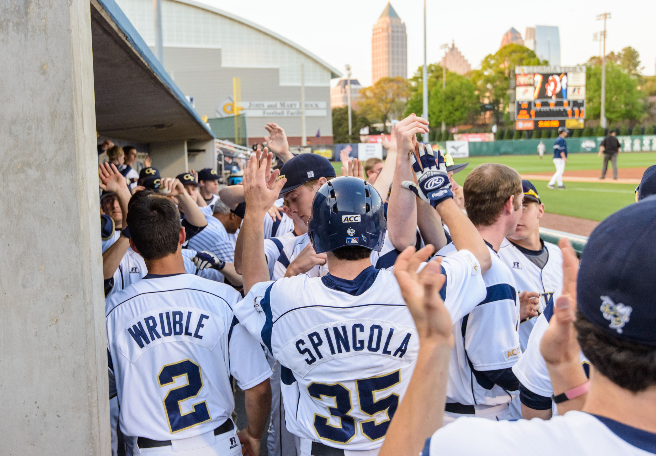 Daniel Spingola (35) is welcomed back to the dugout after scoring a run