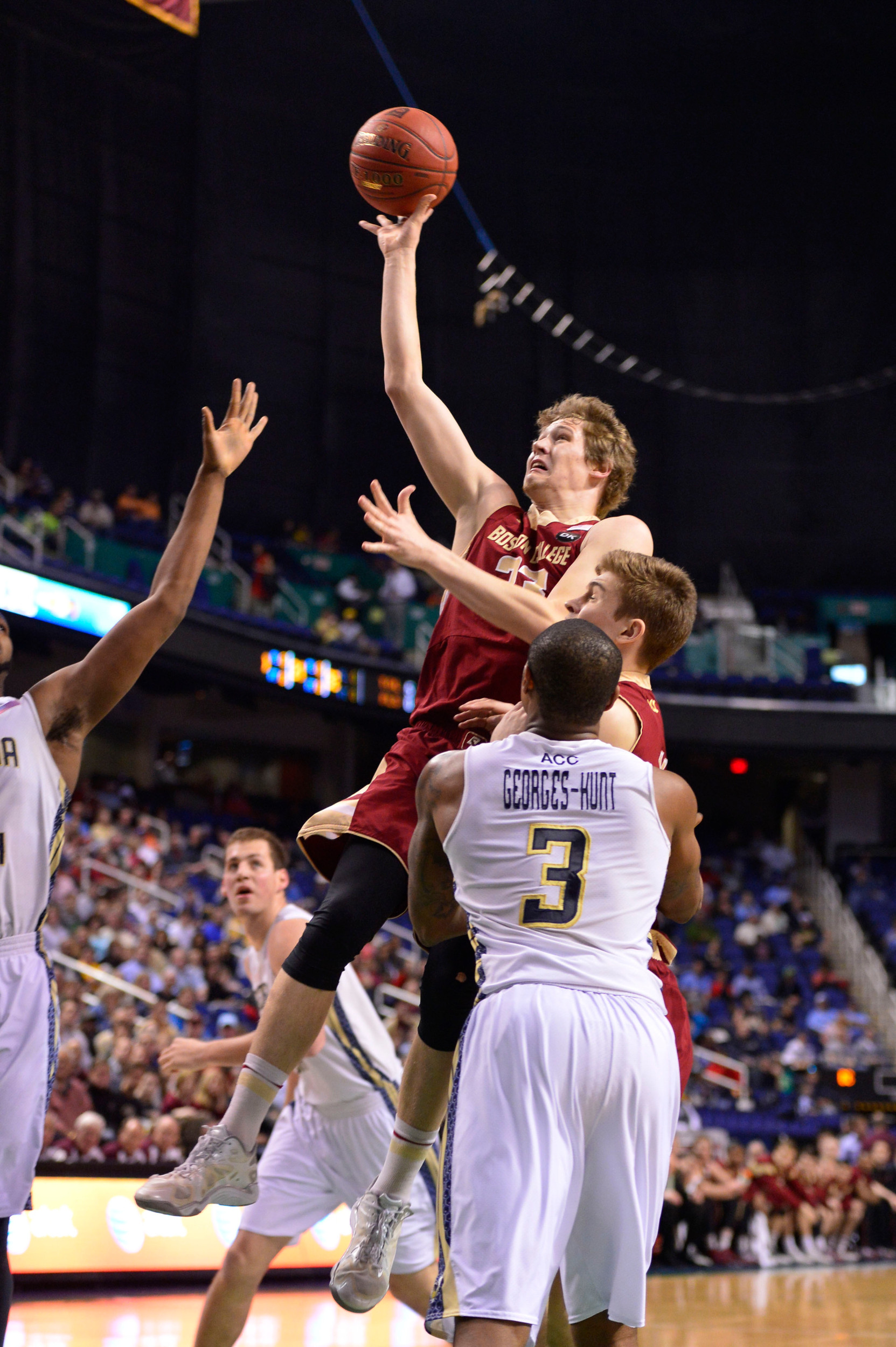 Mar 12, 2014; Greensboro, NC, USA; Boston College Eagles guard Patrick Heckmann (33) shoots as Georgia Tech Yellow Jackets forward Marcus Georges-Hunt (3) defends in the first half in the first round at Greensboro Coliseum. Mandatory Credit: Bob Donnan-USA TODAY Sports