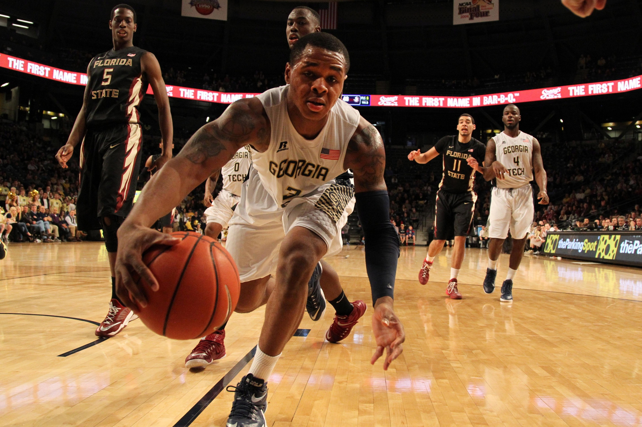 Feb 14, 2015; Atlanta, GA, USA; Georgia Tech Yellow Jackets forward Marcus Georges-Hunt (3) reaches for a loose ball against the Florida State Seminoles in the second half at McCamish Pavilion. Florida State defeated Georgia Tech 57-53.