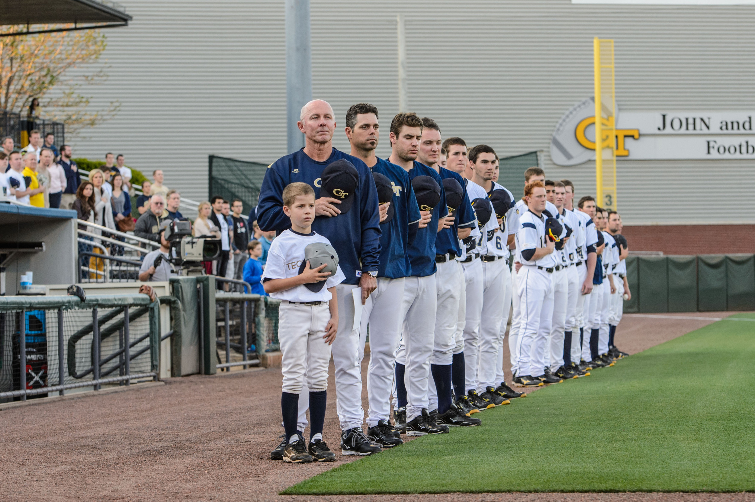 Coach Danny Hall (17) and the Yellow Jackets during the national anthem.