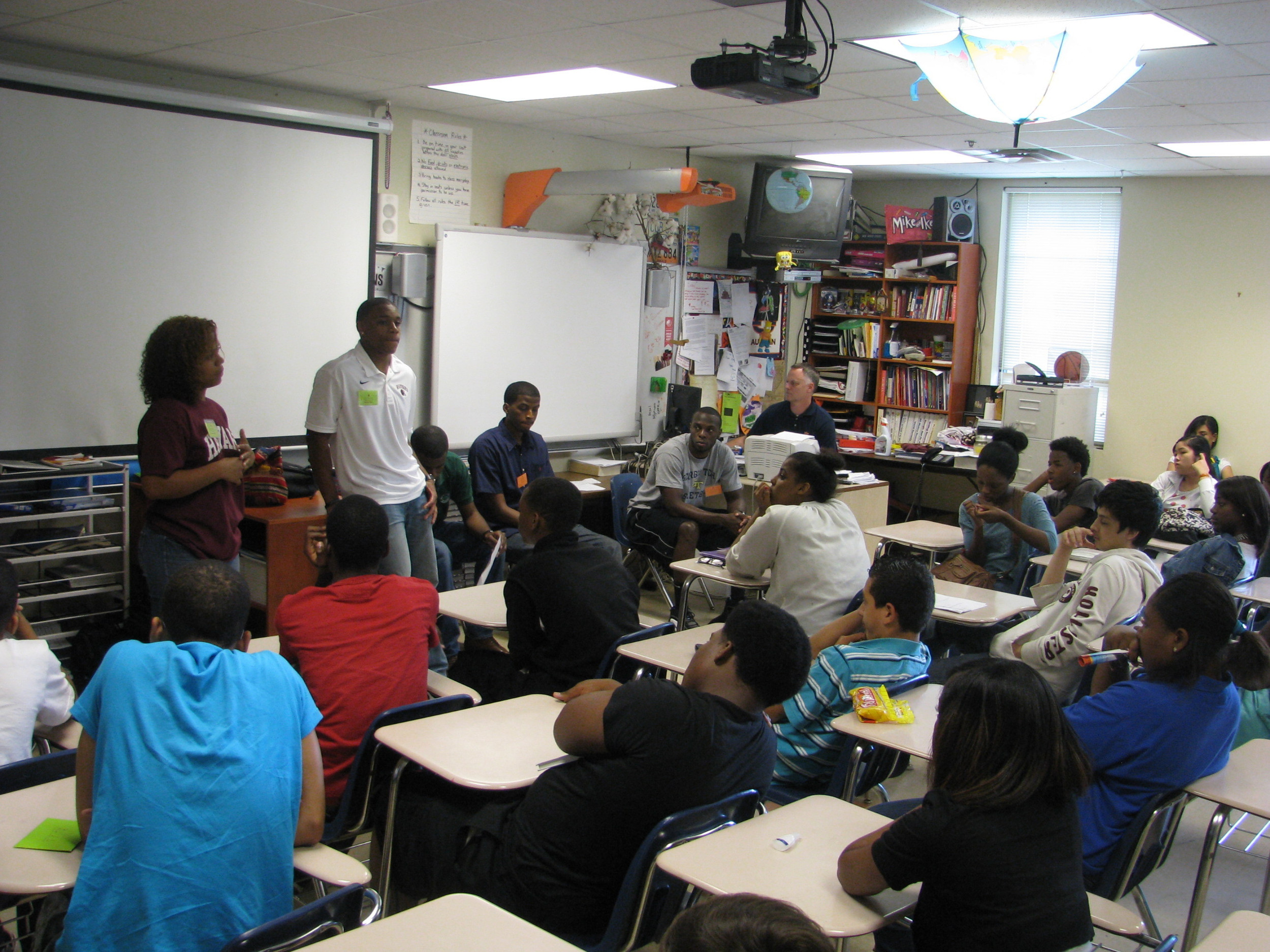 Mfon Udofia joins college students from the area speaking to Tucker Middle School pupils about college life.