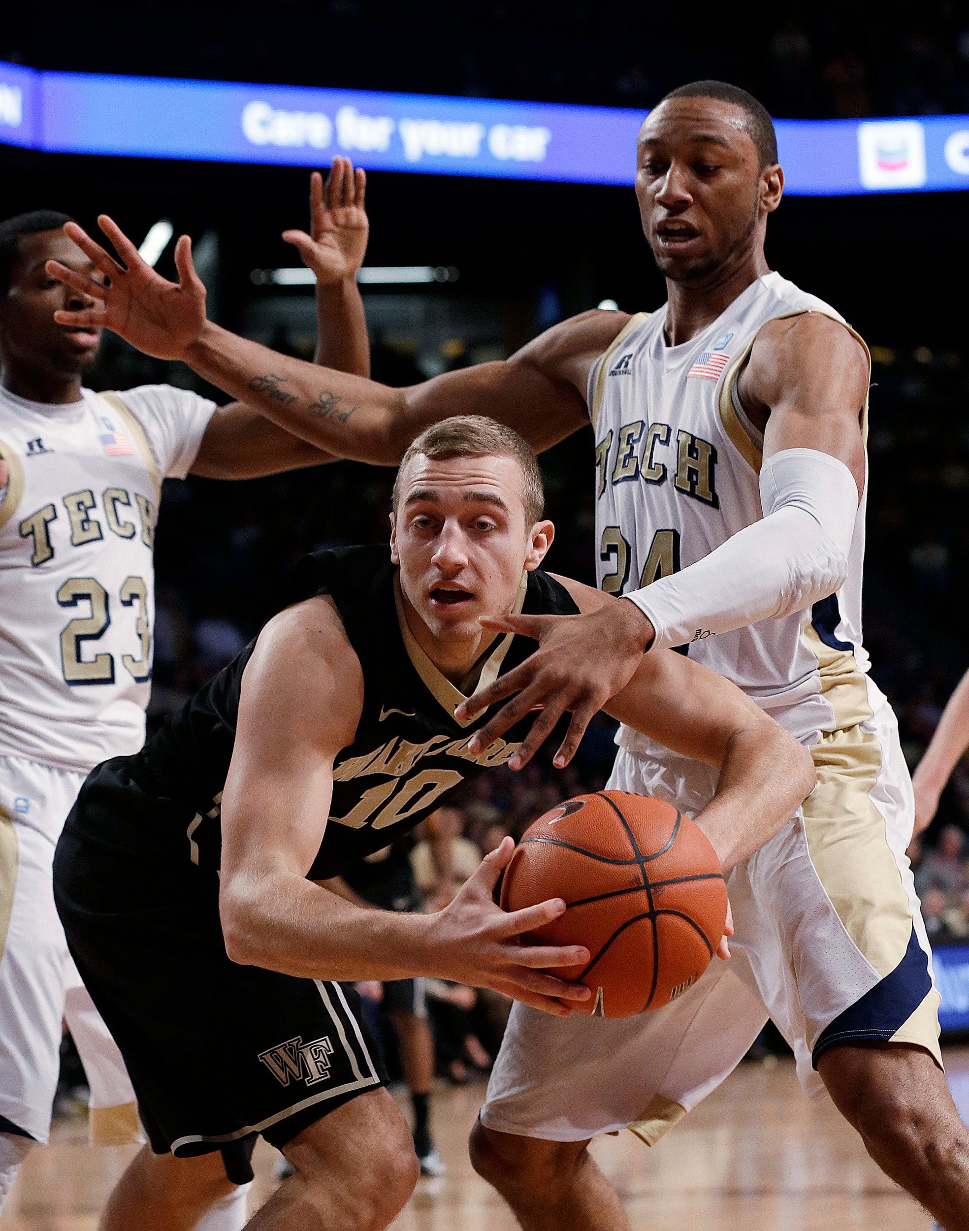 Wake Forest guard Chase Fischer (10) and Georgia Tech forward Kammeon Holsey (24) vie for control of the ball in the first half. (AP Photo/John Bazemore)