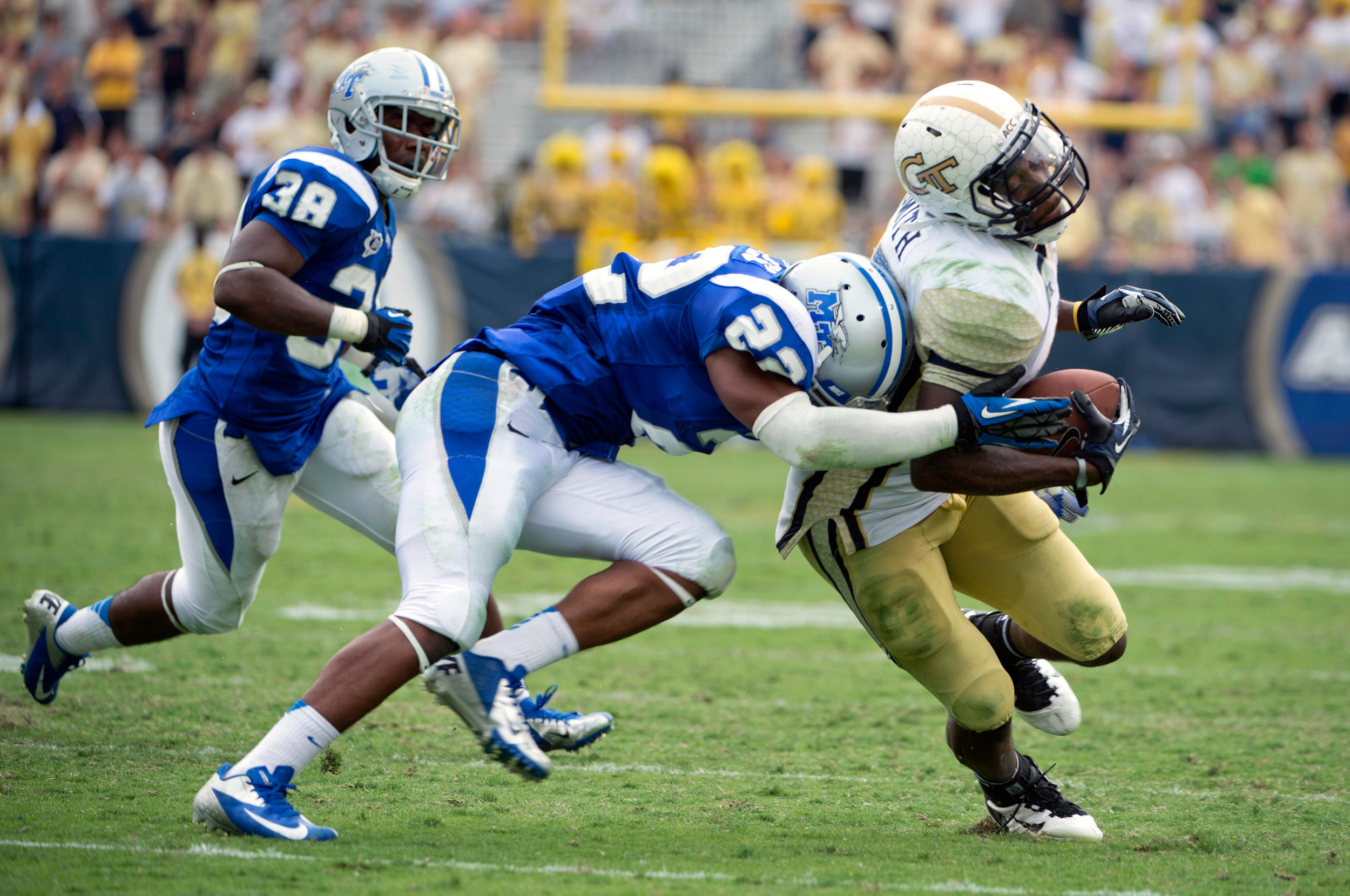 Middle Tennessee State safety David Jones tackles Georgia Tech running back Orwin Smith in the second half. (AP Photo/Rich Addicks)