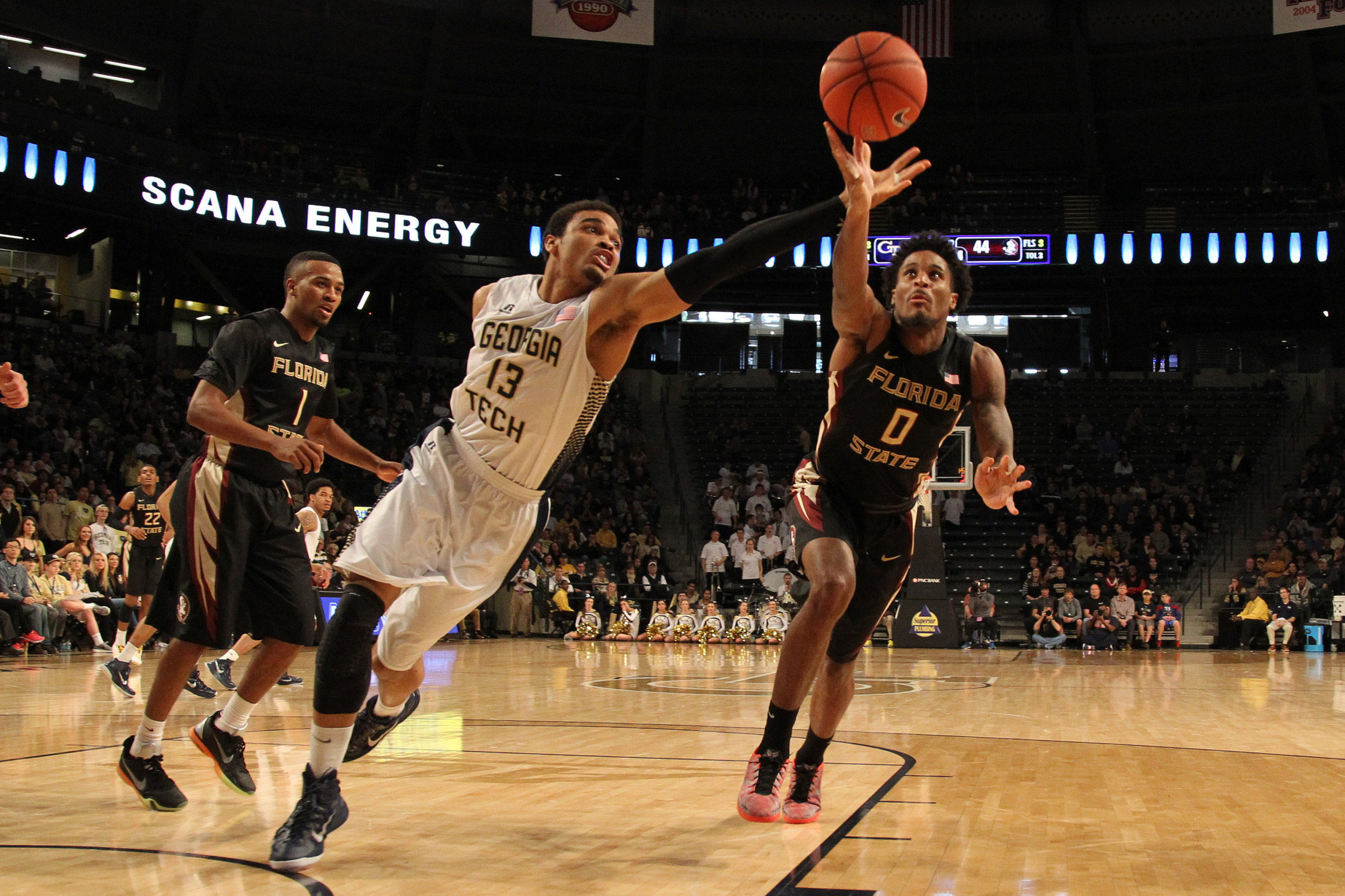 Feb 14, 2015; Atlanta, GA, USA; Georgia Tech Yellow Jackets forward Robert Sampson (13) and Florida State Seminoles forward Phil Cofer (0) reach for a loose ball in the second half at McCamish Pavilion. Florida State defeated Georgia Tech 57-53.