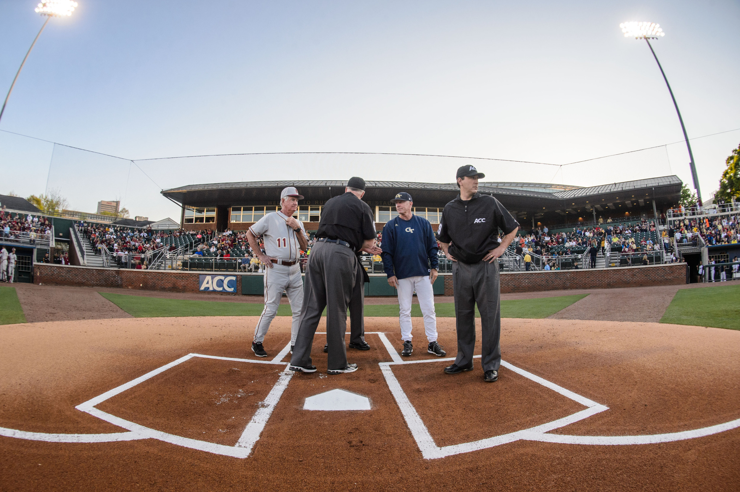 Coach Danny Hall (17) of Georgia Tech and Coach Mike Martin of Florida State meet with the umpires