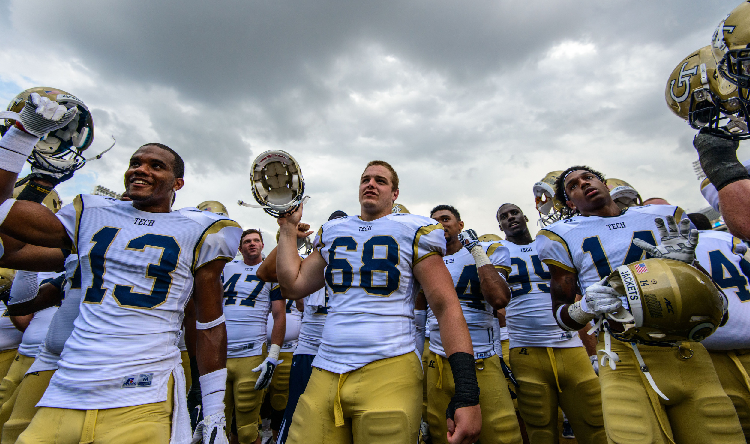 The team sings the fight song with the fans after the win