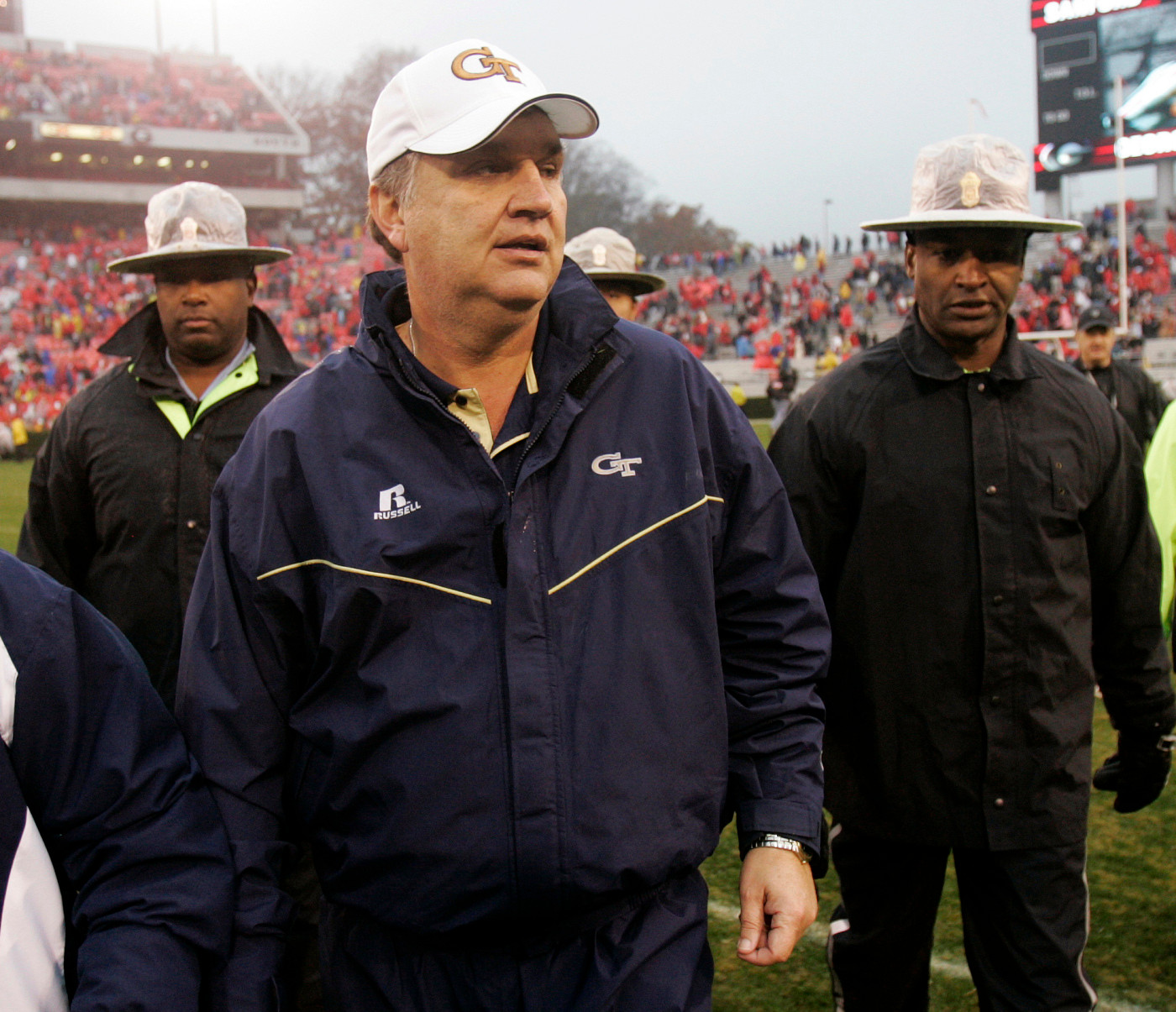 Georgia Tech head coach Paul Johnson, center, is escorted off the field after defeating Georgia 45-42 in Athens, Ga., , Suaturday Nov. 29, 2008. (AP Photo/John Bazemore)
