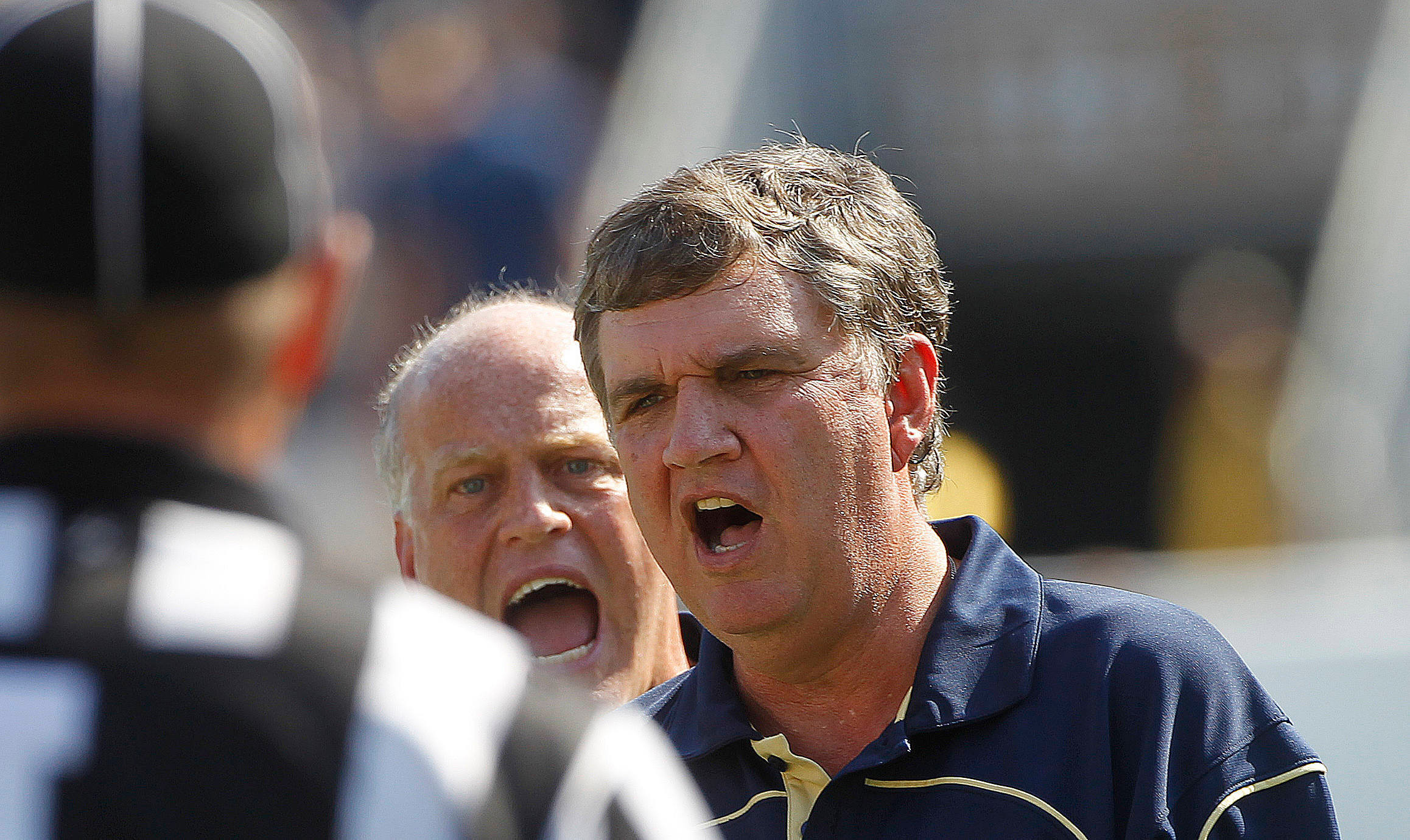 Georgia Tech head coach Paul Johnson, right, and special teams coach Dave Walkosky, center, yell at an official in the first half of an NCAA college football game against the Miami in Atlanta on Saturday, Sept. 22, 2012. (AP Photo/John Bazemore)