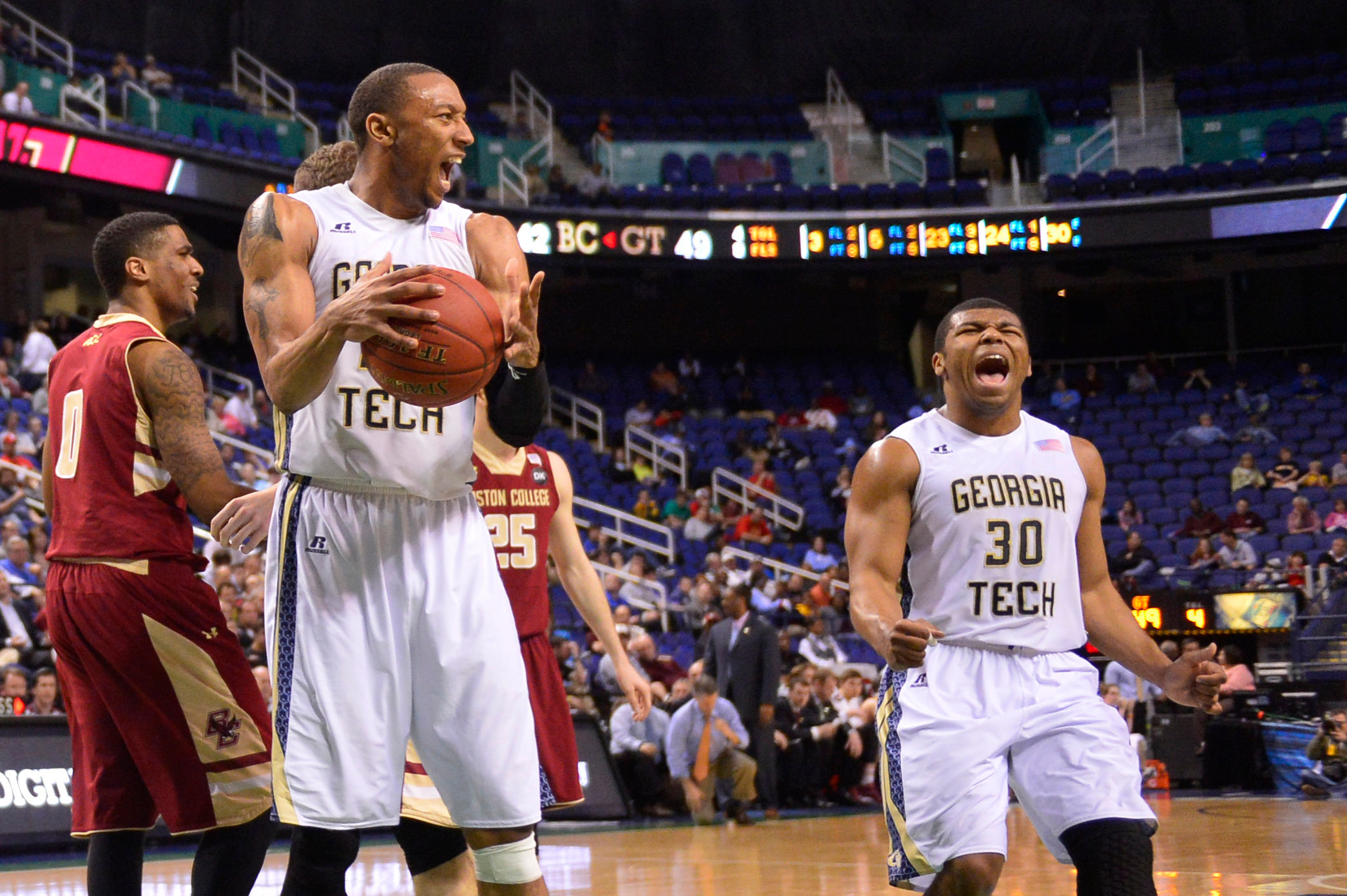 Mar 12, 2014; Greensboro, NC, USA; Georgia Tech Yellow Jackets forward Kammeon Holsey (24) and guard Corey Heyward (30) react in the second half. The Yellow Jackets defeated the Eagles 73-70 in the first round at Greensboro Coliseum. Mandatory Credit: Bob Donnan-USA TODAY Sports