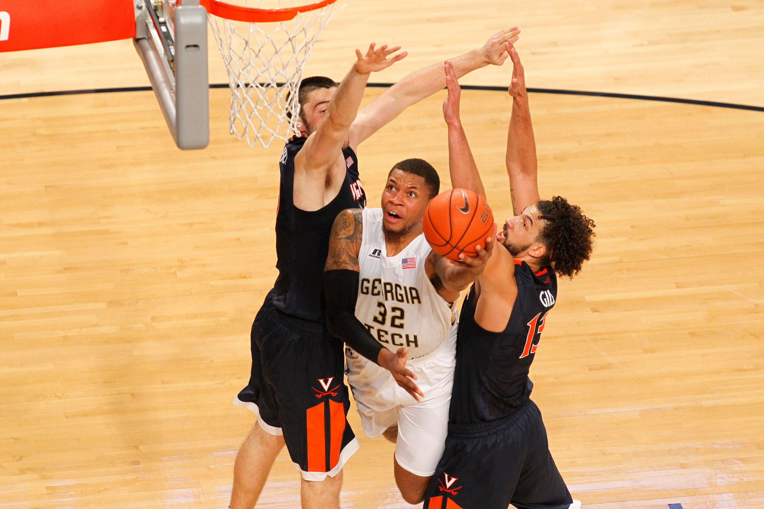 Nick Jacobs shoots through Virginia Cavaliers center Mike Tobey and forward Anthony Gill. Brett Davis-USA TODAY Sports