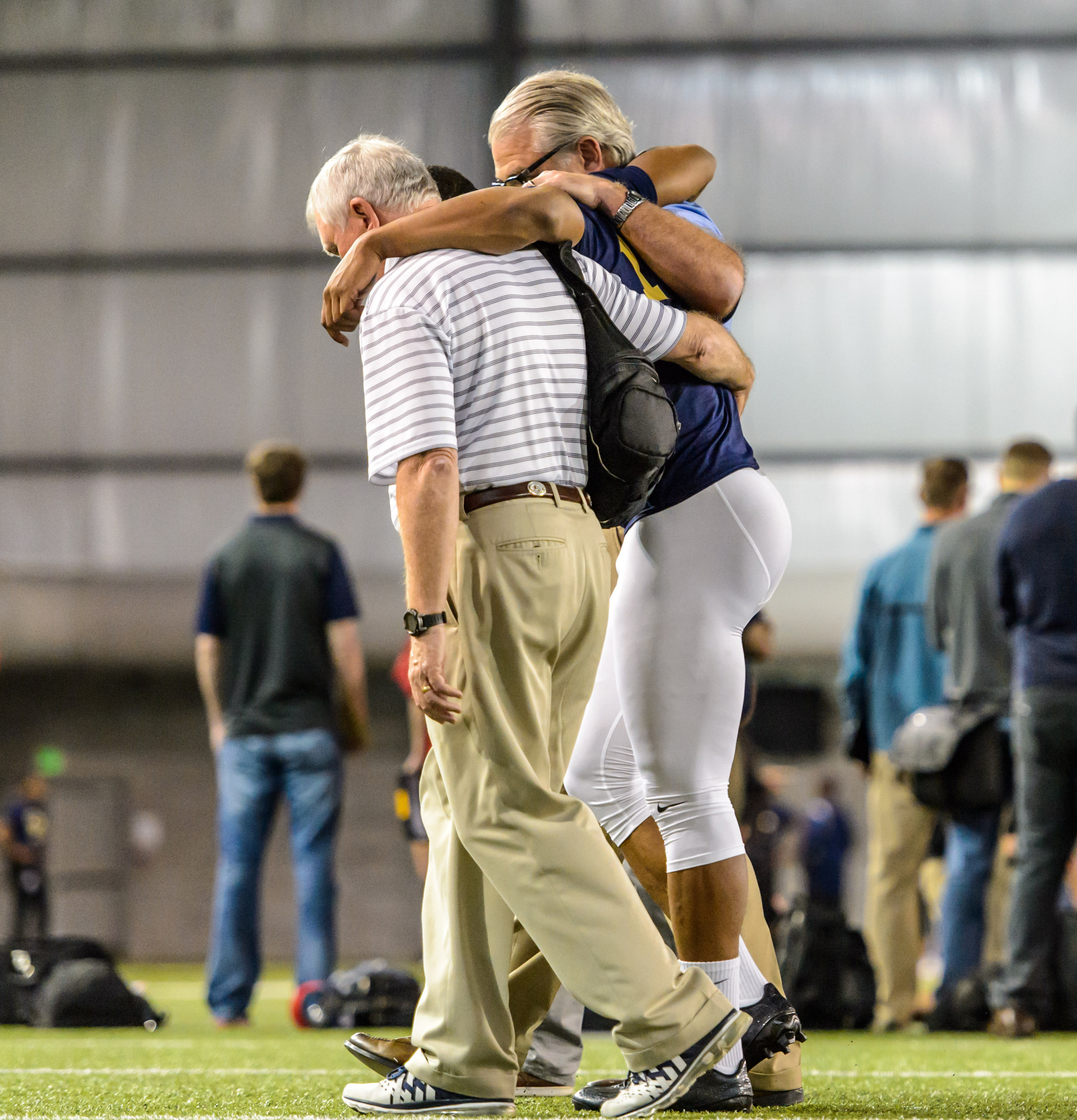 Director of Sports Medicine Jay Shoop and Coach Ted Roof help Demond Smith (12)