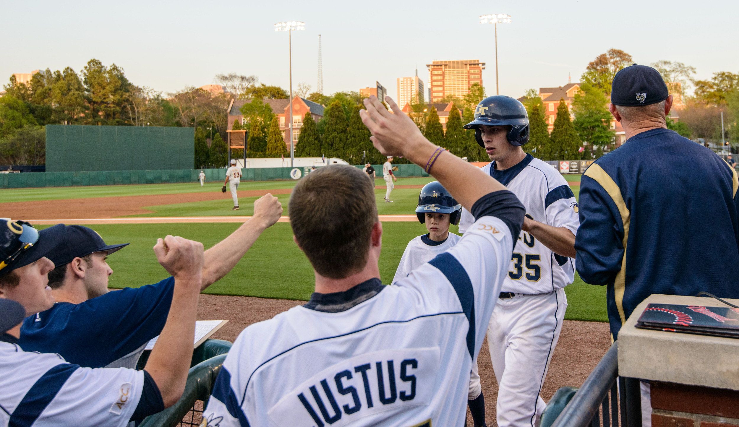 Daniel Spingola (35) is welcomed back to the dugout after scoring a run