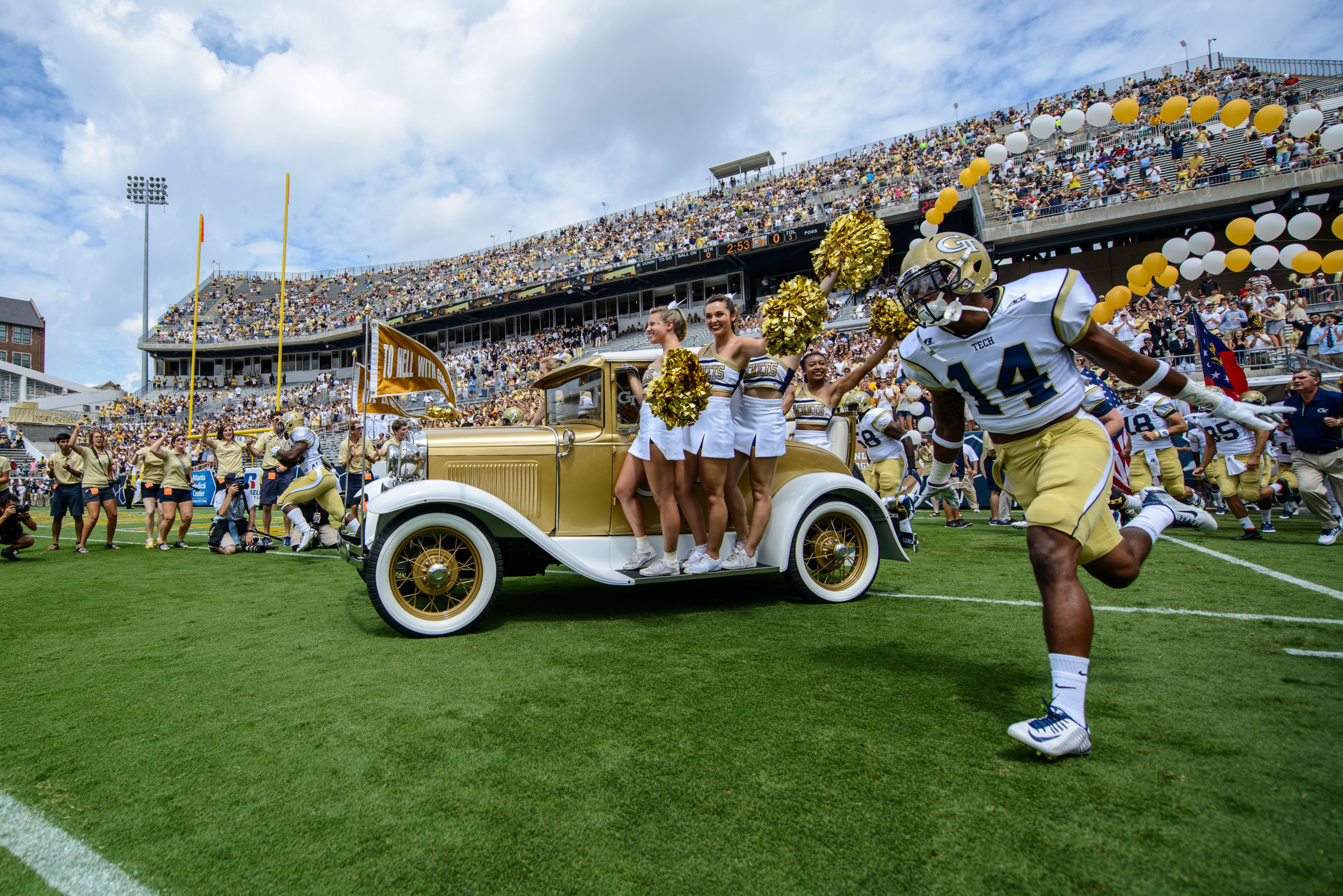 The Ramblin' Reck leads the team on the field