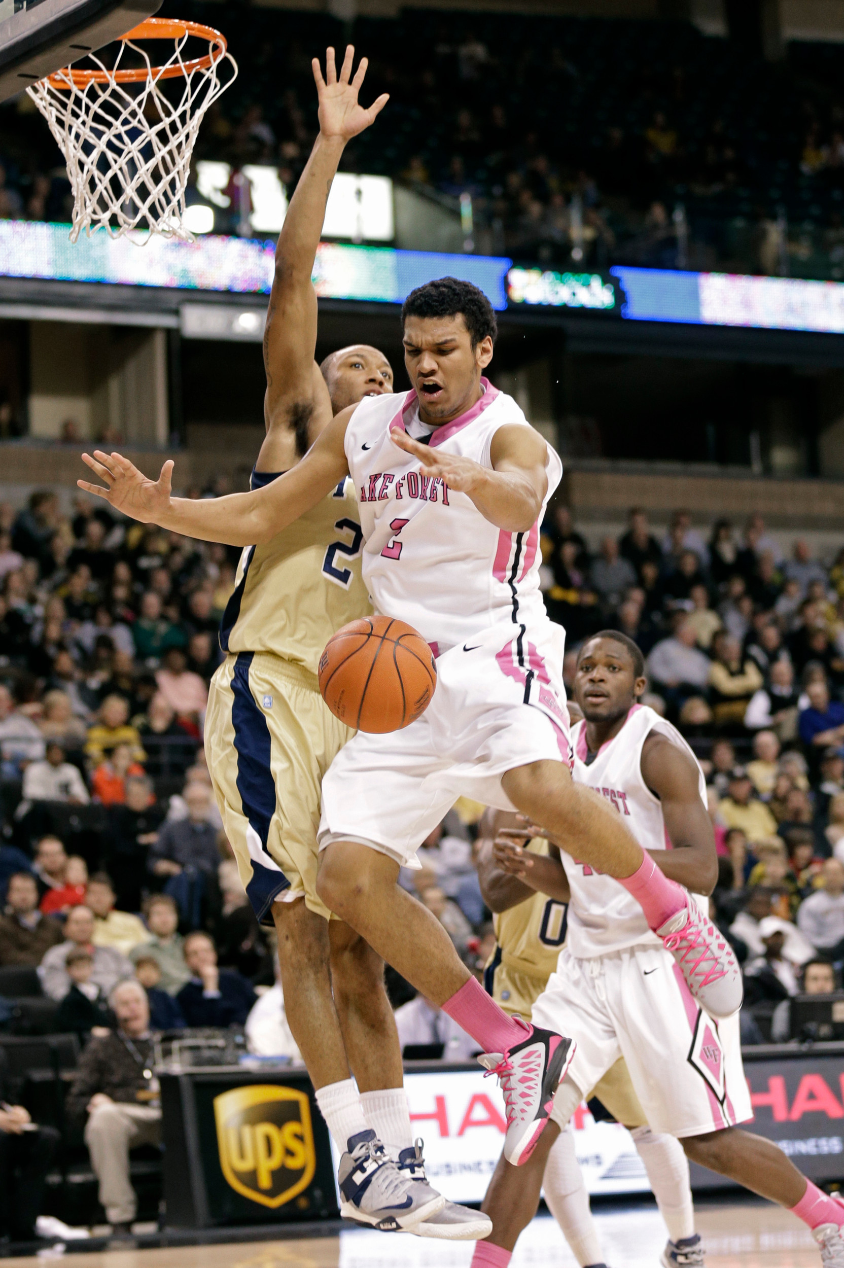 Wake Forest's Devin Thomas, right, is defended by Georgia Tech's Kammeon Holsey, left, during the first half. (AP Photo/Chuck Burton)