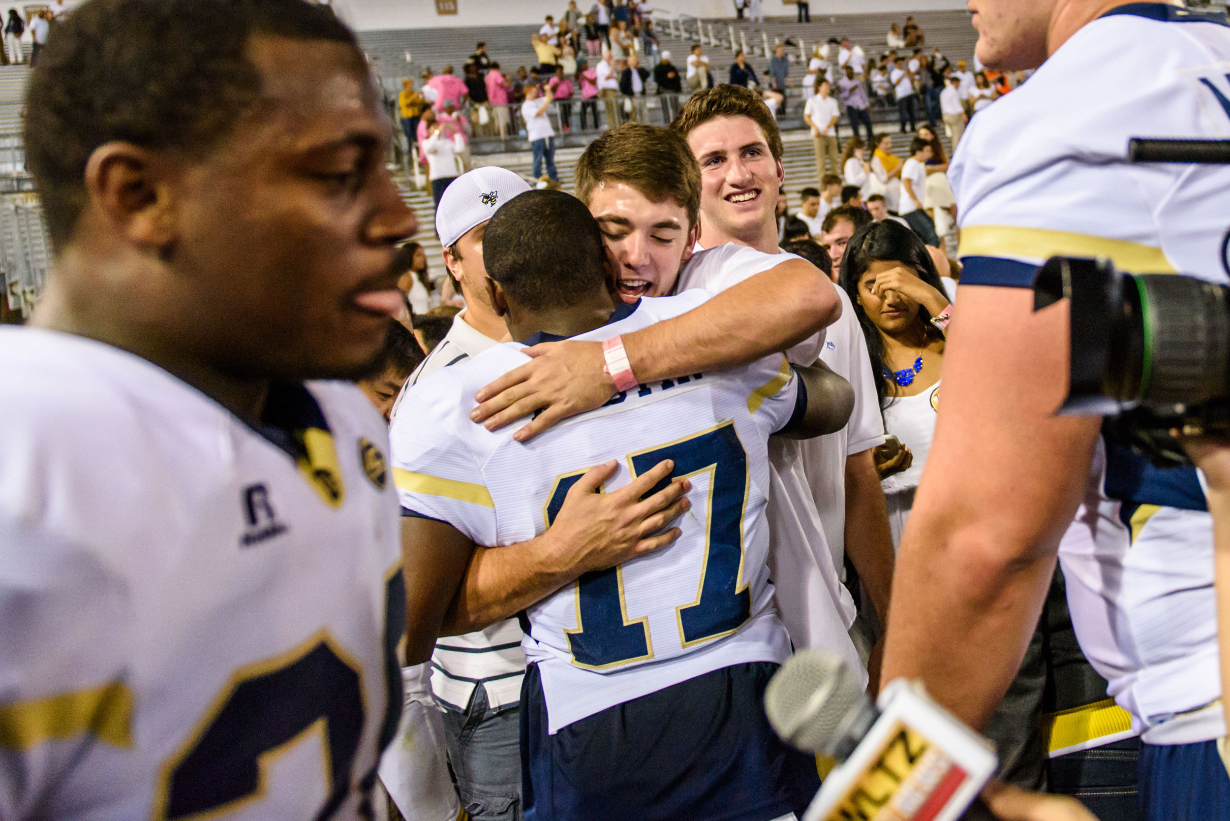 Lance Austin (17) embraces a fan after the upset victory