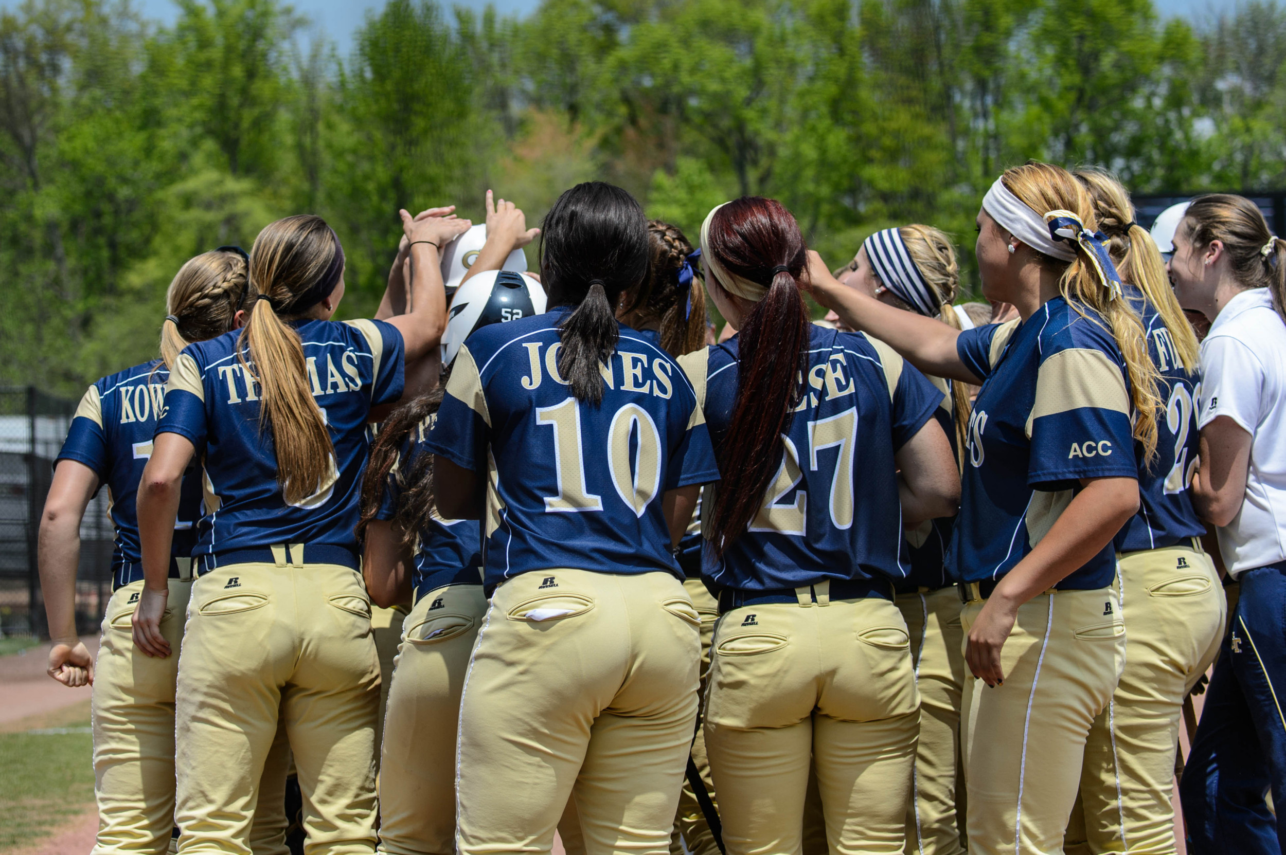 The team welcomes Alysha Rudnik (25) to the plate after her homerun