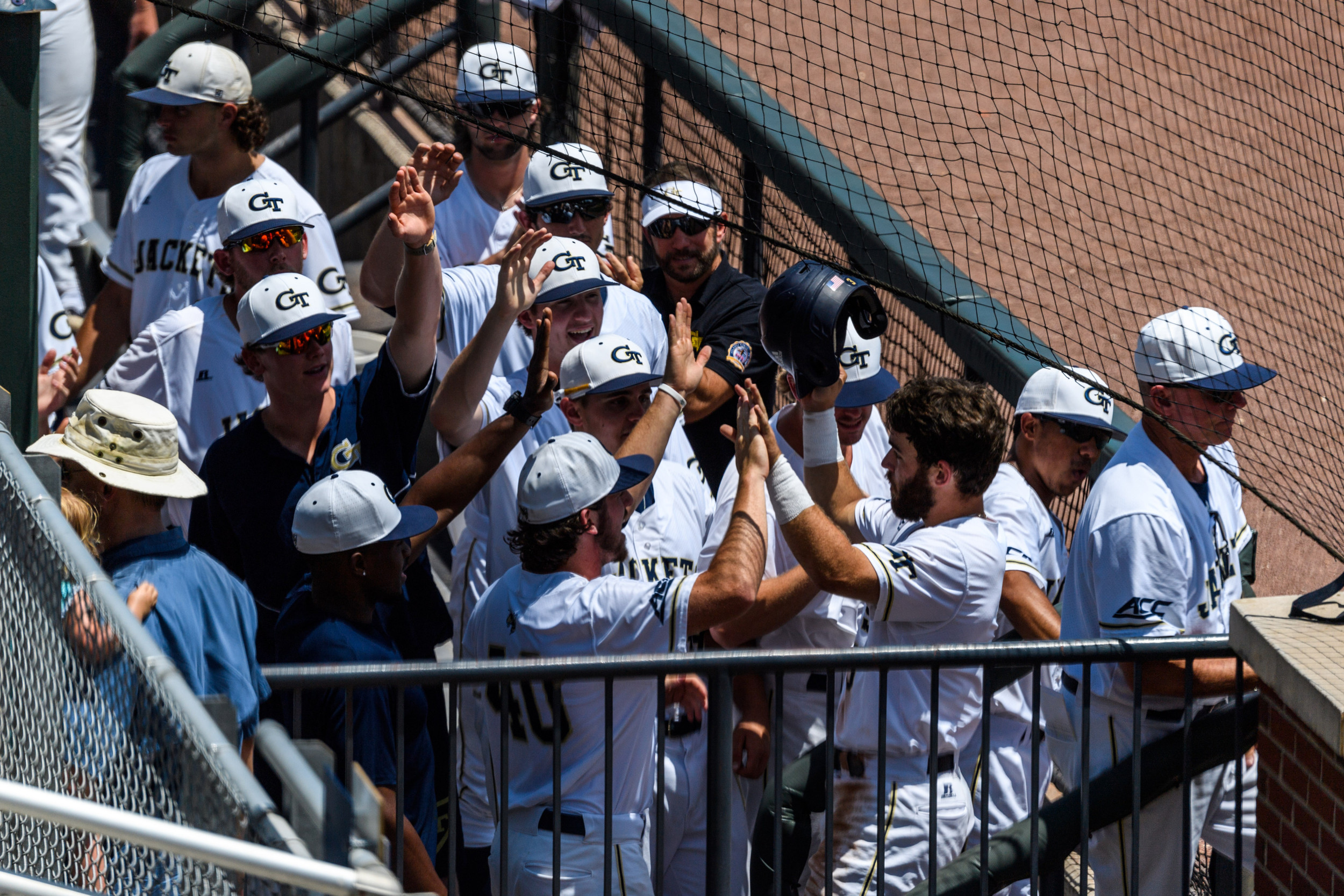 The team welcomes Wade Bailey (3) back to the dugout after a homerun
