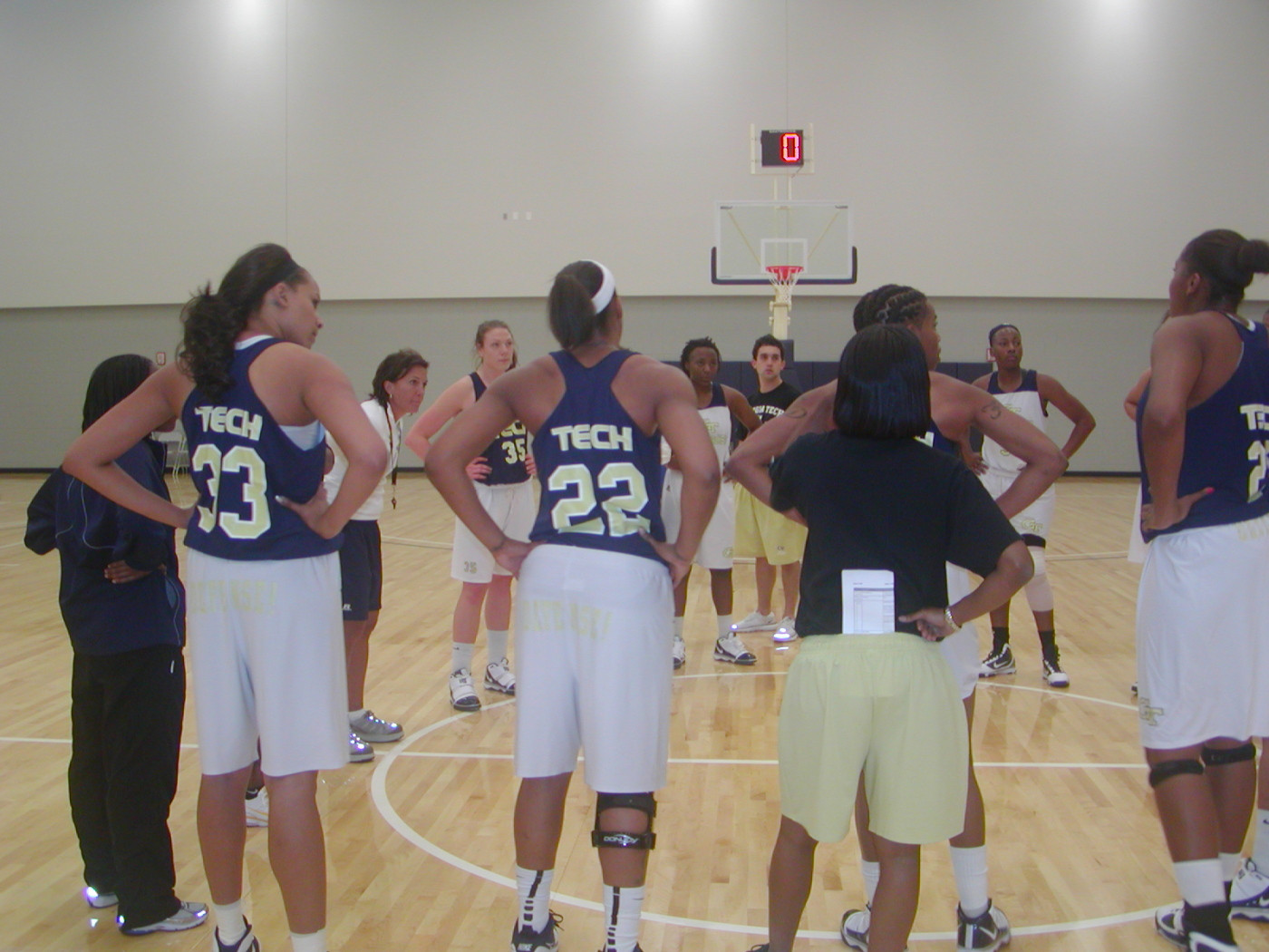 Coach Joseph addresses team before practice on the brand new Zelnak Center floor