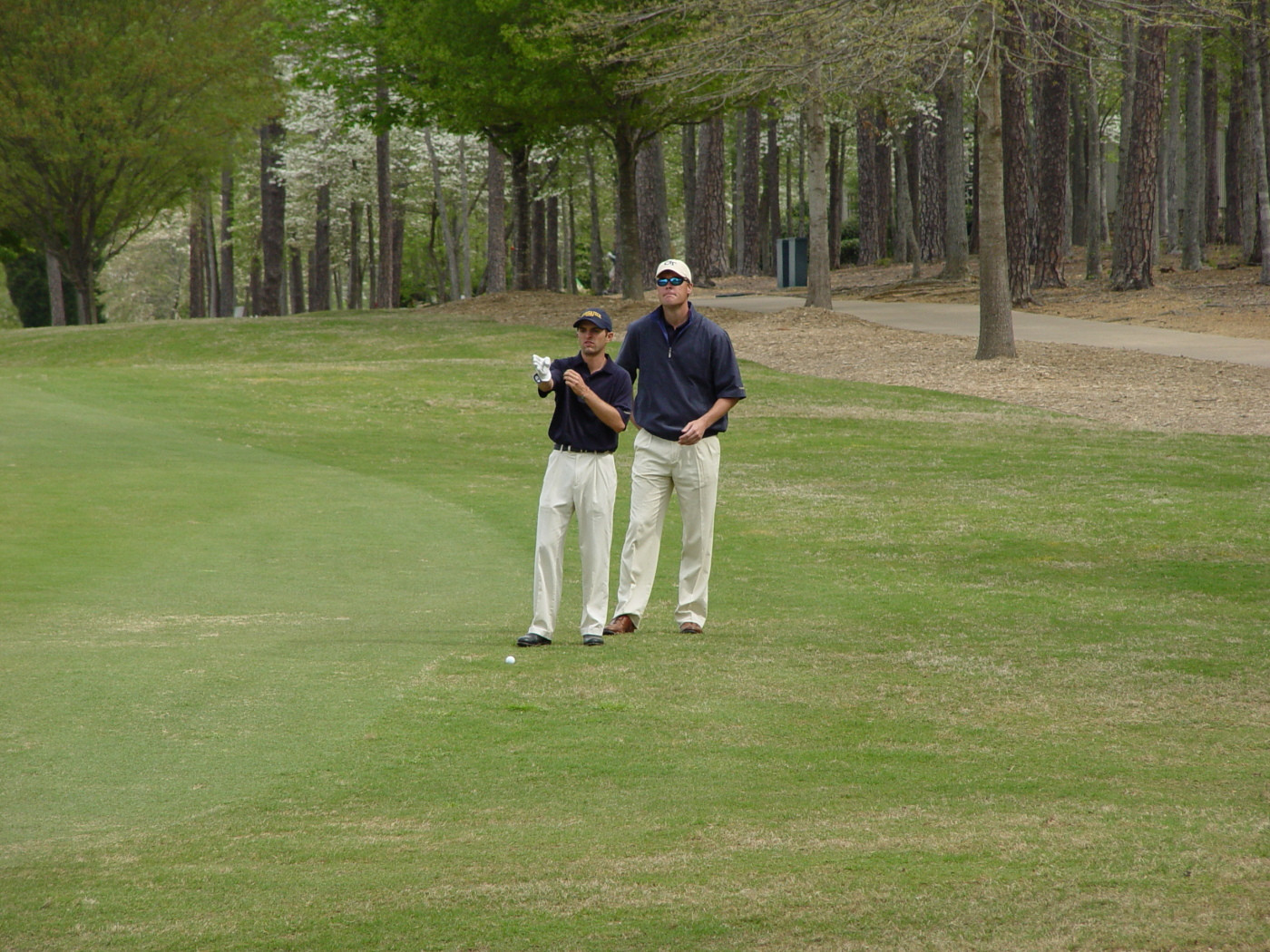 David Dragoo (front) sizes up a fairway shot with assistant coach Christian Newton during round two of the ACC Golf Championship, April 19, 2008.