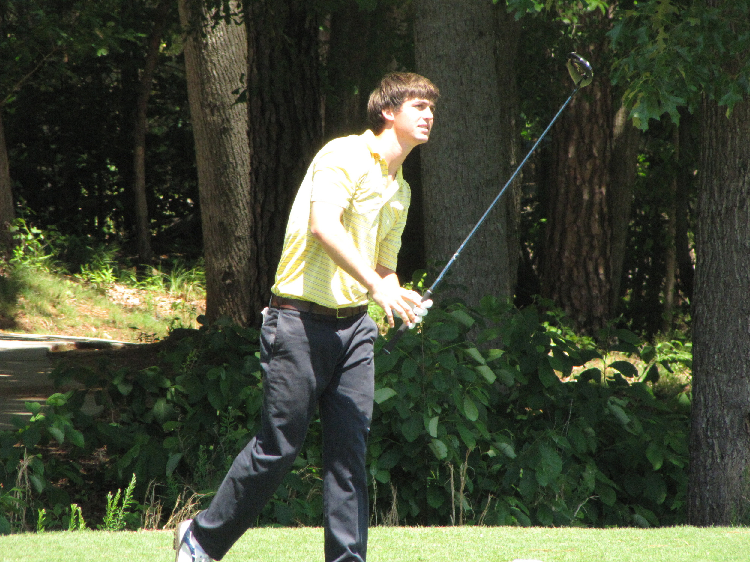 Ollie Schniederjans watches the flight of his tee shot at 15 Friday at the NCAA Raleigh Regional, May 16, 2014