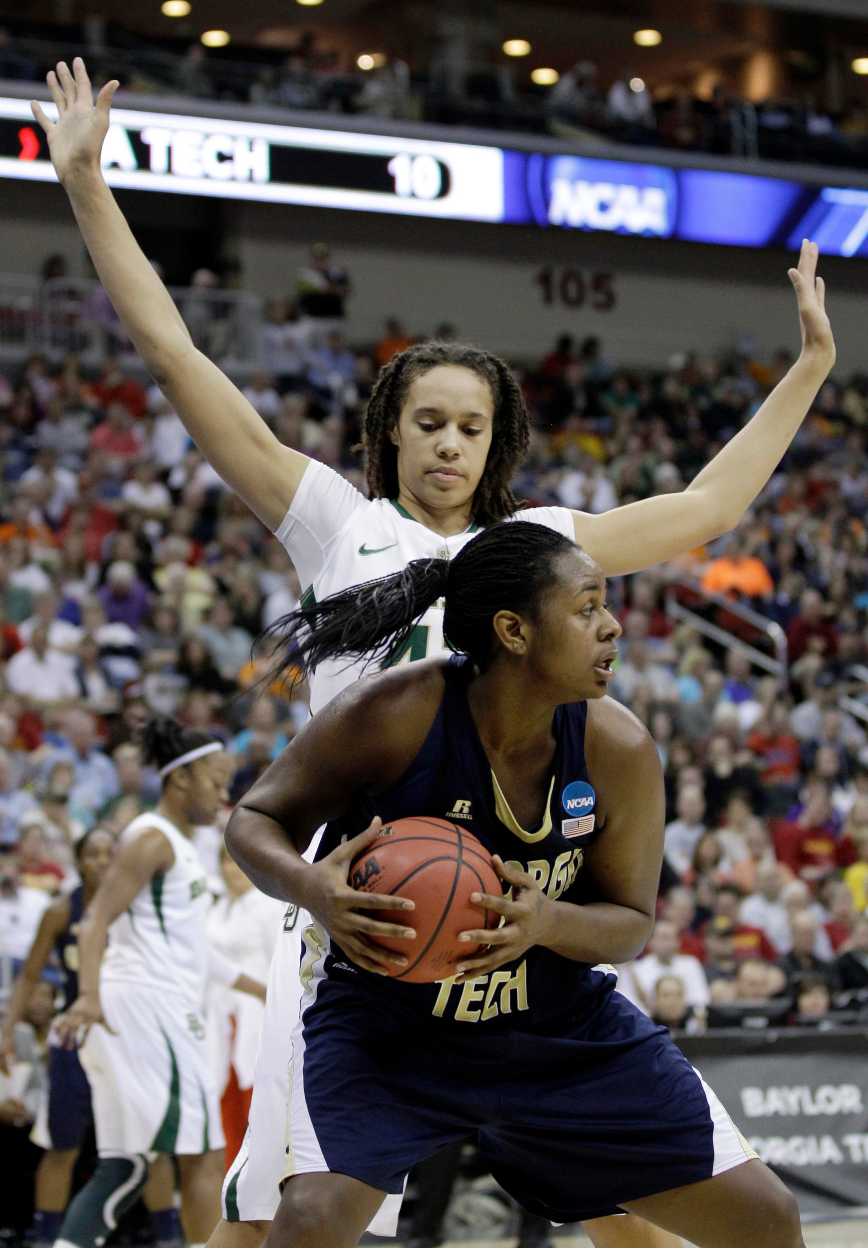 Georgia Tech center Sasha Goodlett looks to pass in front of Baylor center Brittney Griner, rear, during the first half. (AP Photo/Charlie Neibergall)