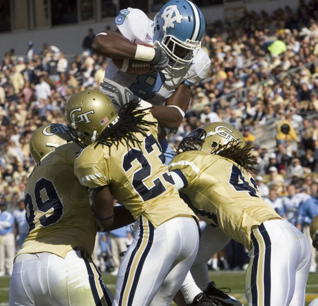 Vance Walker (99), Djay Jones (23), and Philip Wheeler, right, stop North Carolina's Greg Little in a goal line stand during the first half in Atlanta. (AP Photo/John Amis)