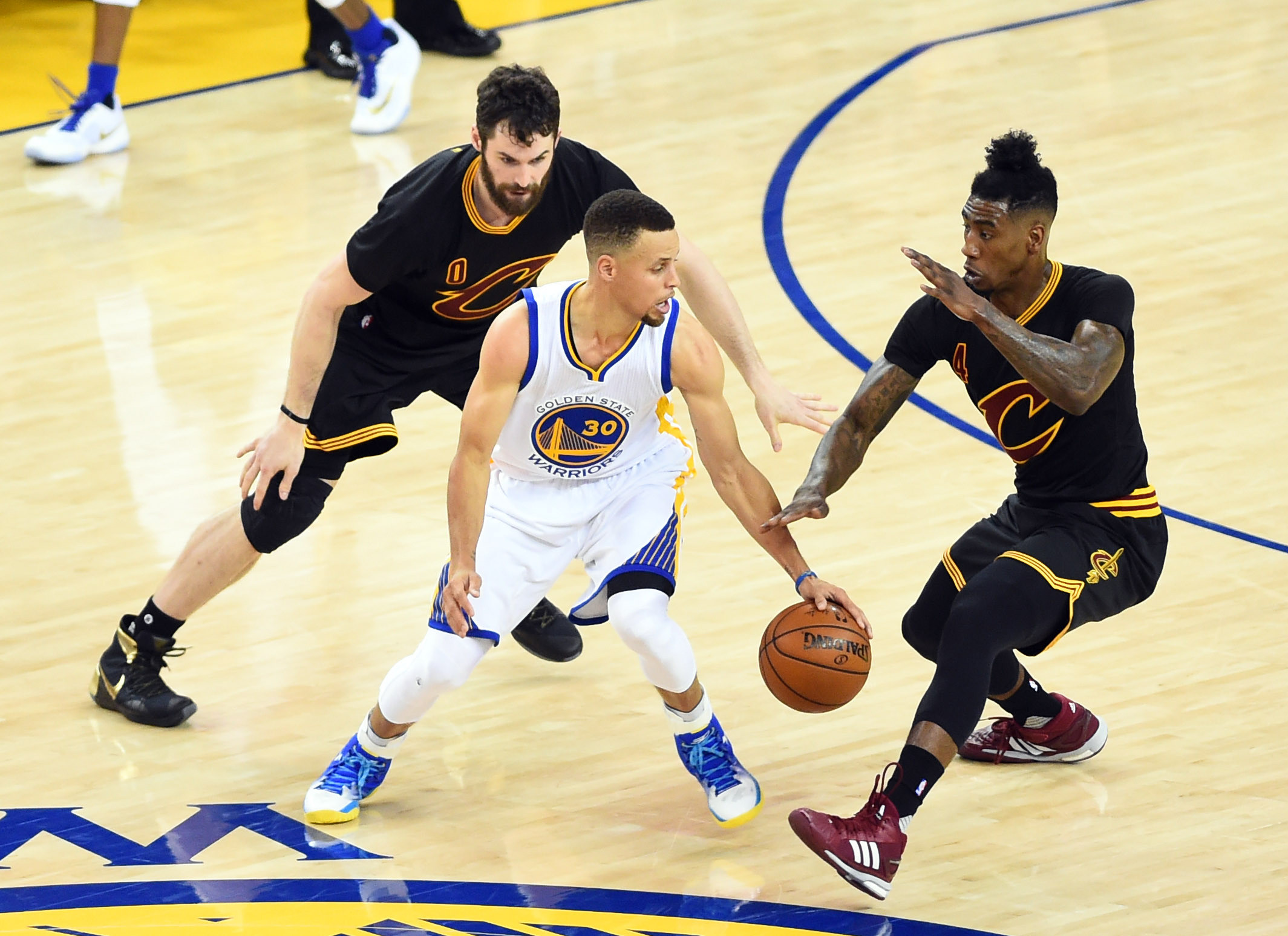 Jun 13, 2016; Oakland, CA, USA; Golden State Warriors guard Stephen Curry (30) handles the ball against Cleveland Cavaliers guard Iman Shumpert (4) and forward Kevin Love (0) during game five of the NBA Finals. Credit: Bob Donnan-USA TODAY Sports