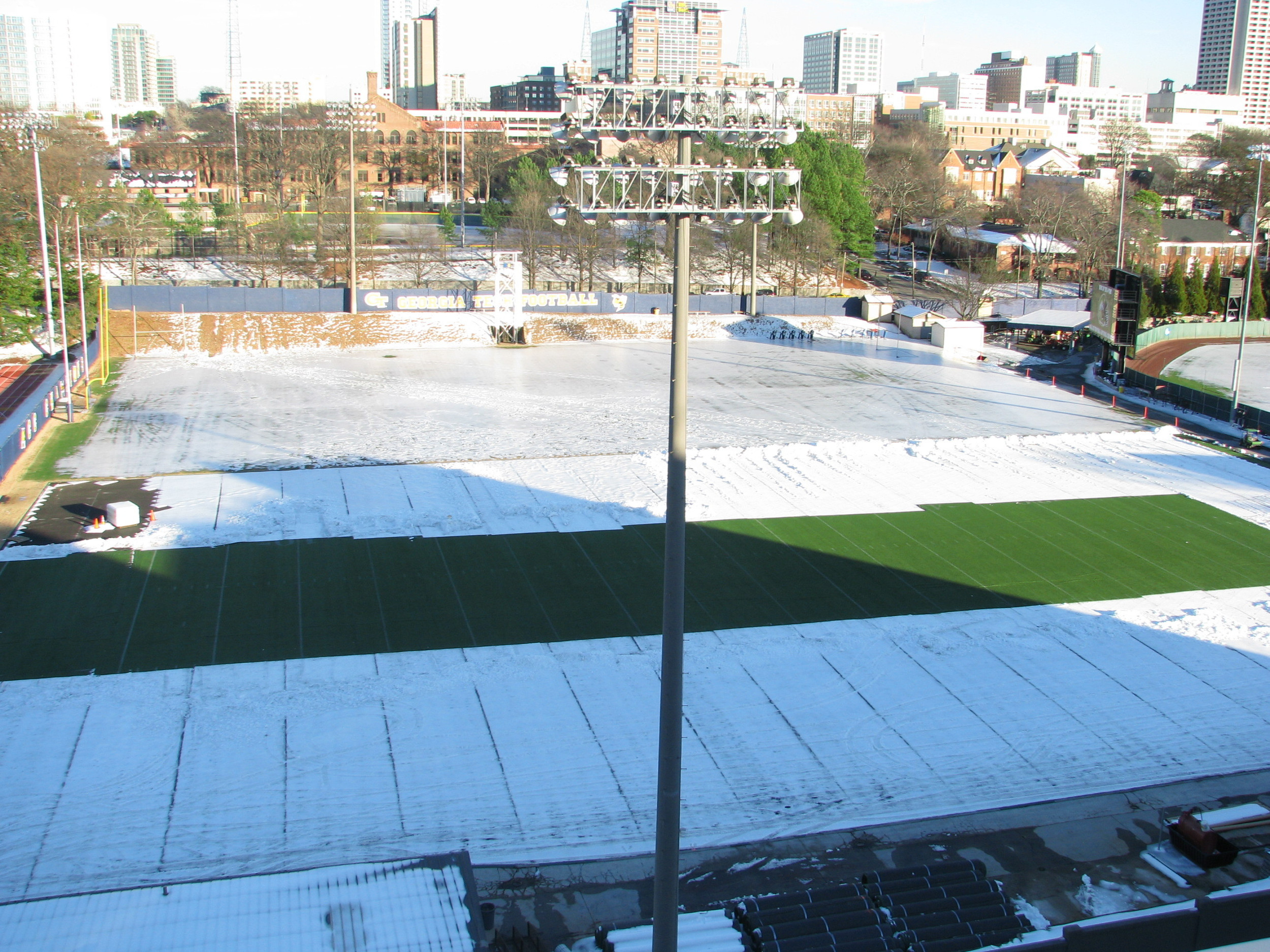 Week 2 - Photo taken on Jan. 14, 2011 - Snow and ice on most of field but they have cleared part of the area where future indoor facility is going.