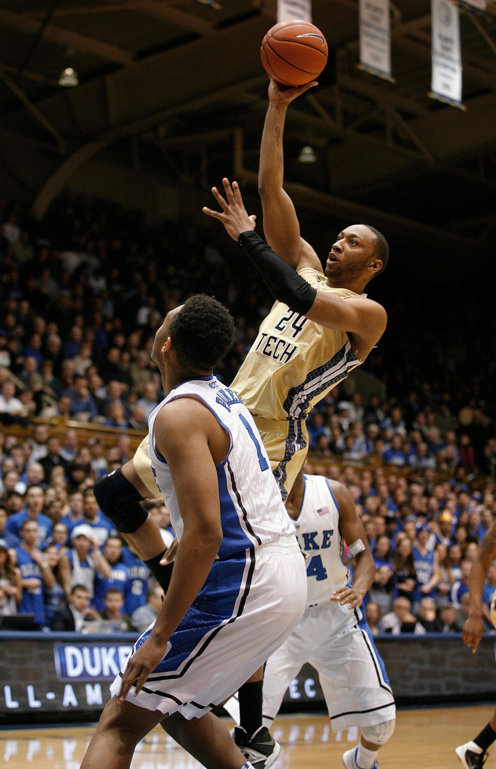 Jan 7, 2014; Durham, NC, USA; Georgia Tech Yellow Jackets forward Kammeon Holsey (24) shoots over Duke Blue Devils forward Jabari Parker (1) at Cameron Indoor Stadium. Mandatory Credit: Mark Dolejs-USA TODAY Sports