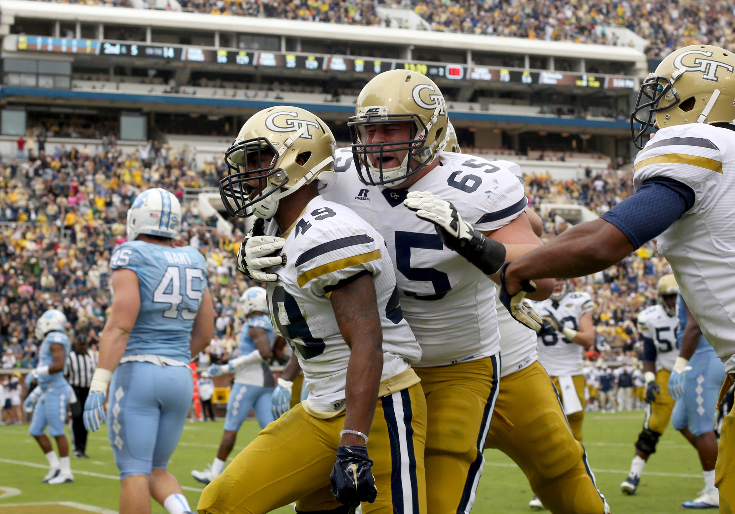 Clinton Lynch celebrates with offensive lineman Trey Klock after Lynch's touchdown. Jason Getz-USA TODAY Sports