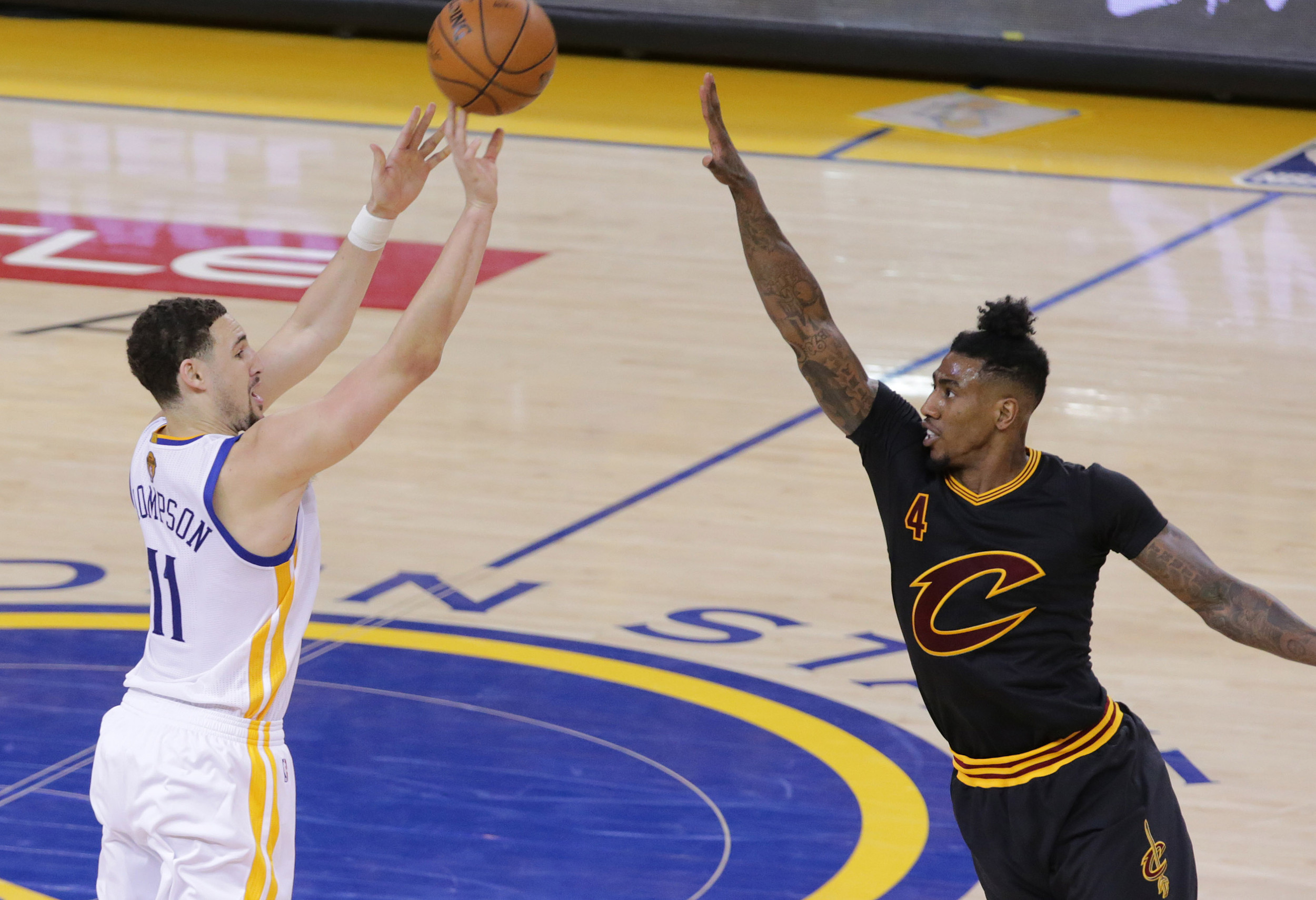 June 13, 2016; Oakland, CA, USA; Golden State Warriors guard Klay Thompson (11) shoots against Cleveland Cavaliers guard Iman Shumpert (4) during game five of the NBA Finals. Credit: Kelley L Cox-USA TODAY Sports