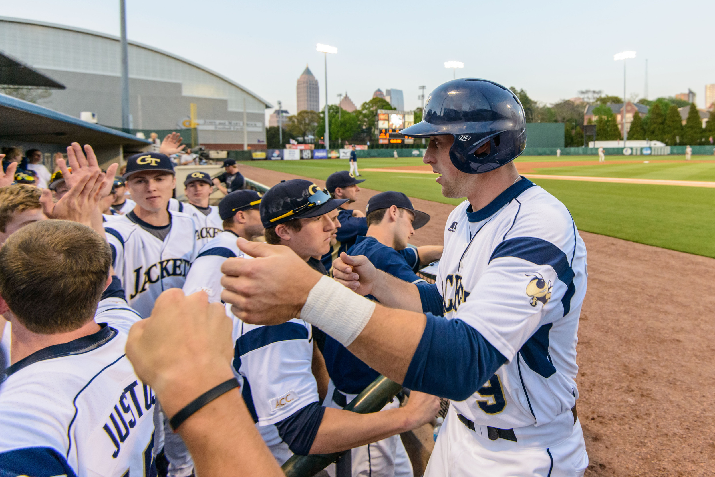 A.J. Murray (9) is welcomed back to the dugout after scoring a run