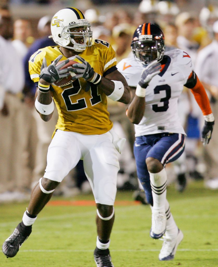 Georgia Tech wide receiver Calvin Johnson (21) pulls down a second-half pass in front of Virginia cornerback Marcus Hamilton (3) on the way to scoring a touchdown. (AP Photo/Ric Feld)