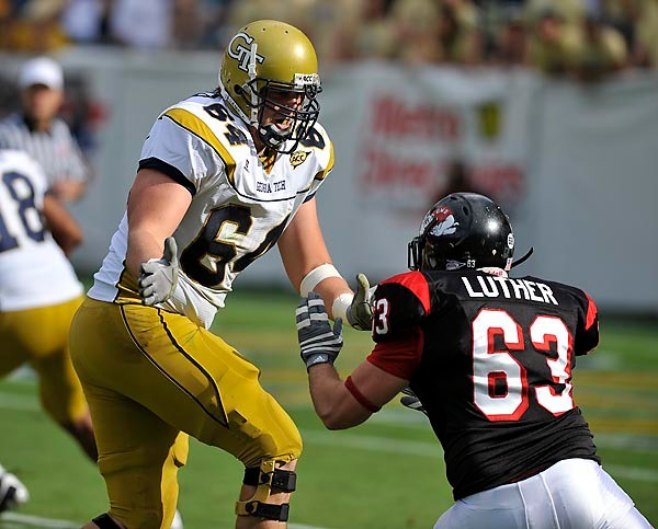 Andrew Gardner (64) blocks a Gardner-Webb player. (Photo by LensEffects)