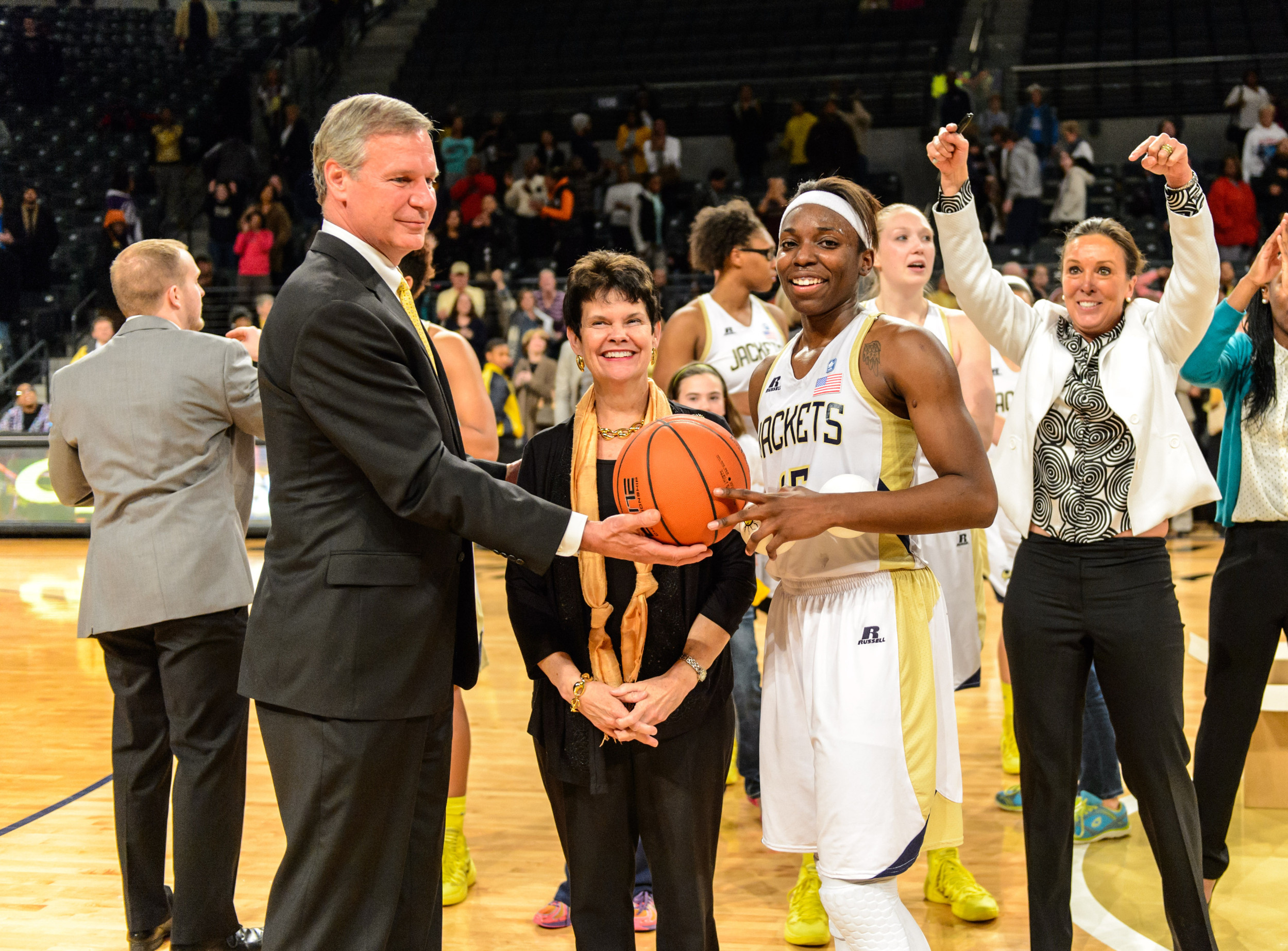 President Bud Peterson and his wife, Val, present Ty Marshall (15) with the game ball after she scored 32 points and broke the Georgia Tech Women's Basketball career scoring record.