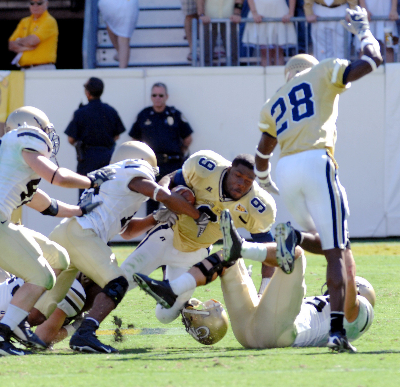 Josh Nesbitt loses his helmet as he is tackled by Army safety Dennis Cooperon a drive during the fourth quarter. (AP Photo/Gregory Smith)