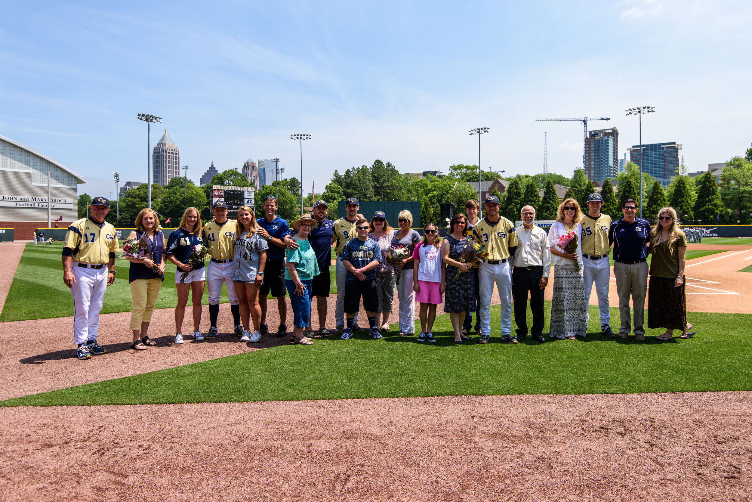 A.J. Murray (9), Thomas Smith (13), Daniel Spingola (35), Devin Stanton (41), and their families pose with Coach Danny Hall (17) on Senior Day
